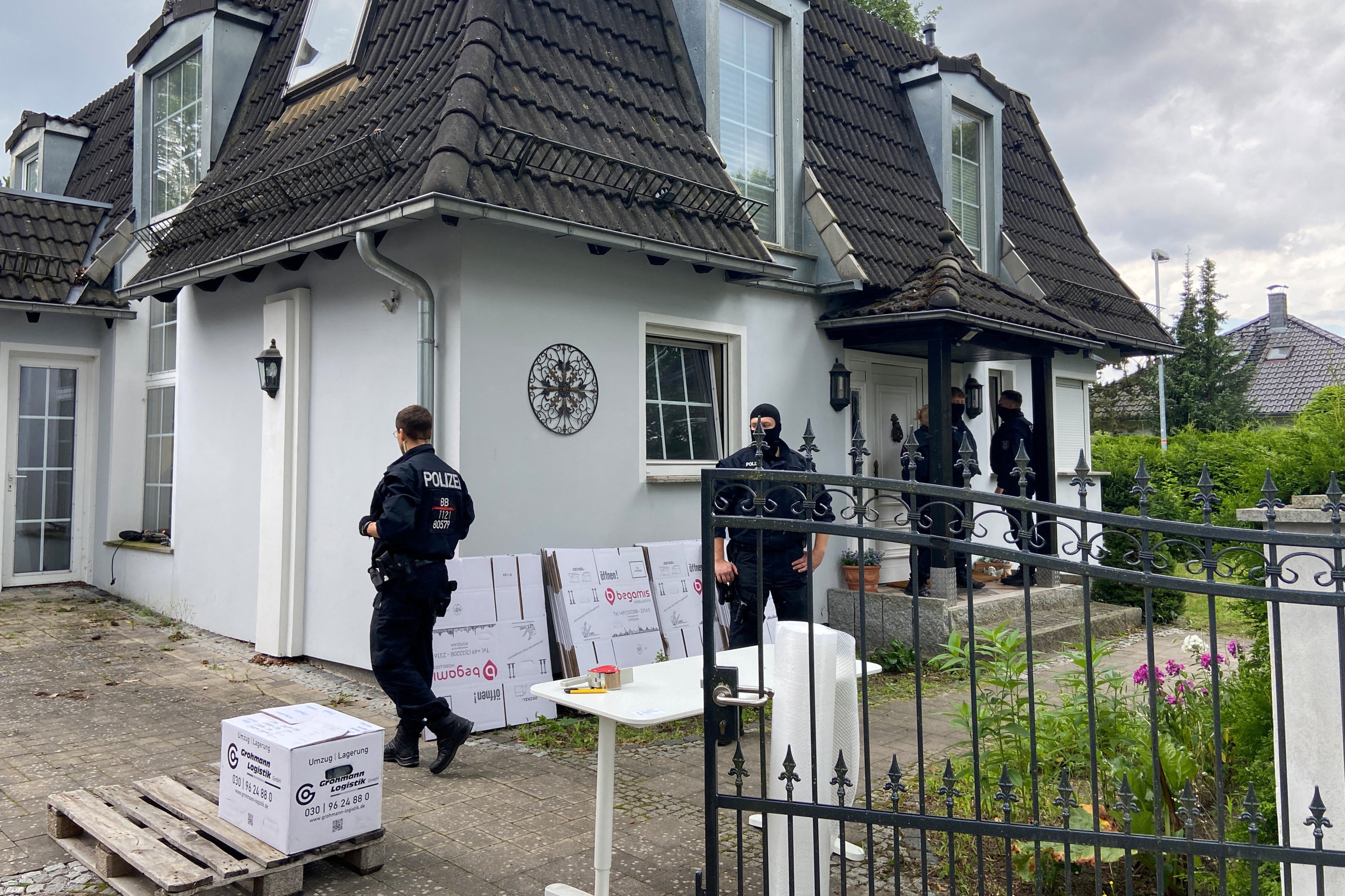 Police at a house in Falkensee near Berlin. Searches were conducted in four German states