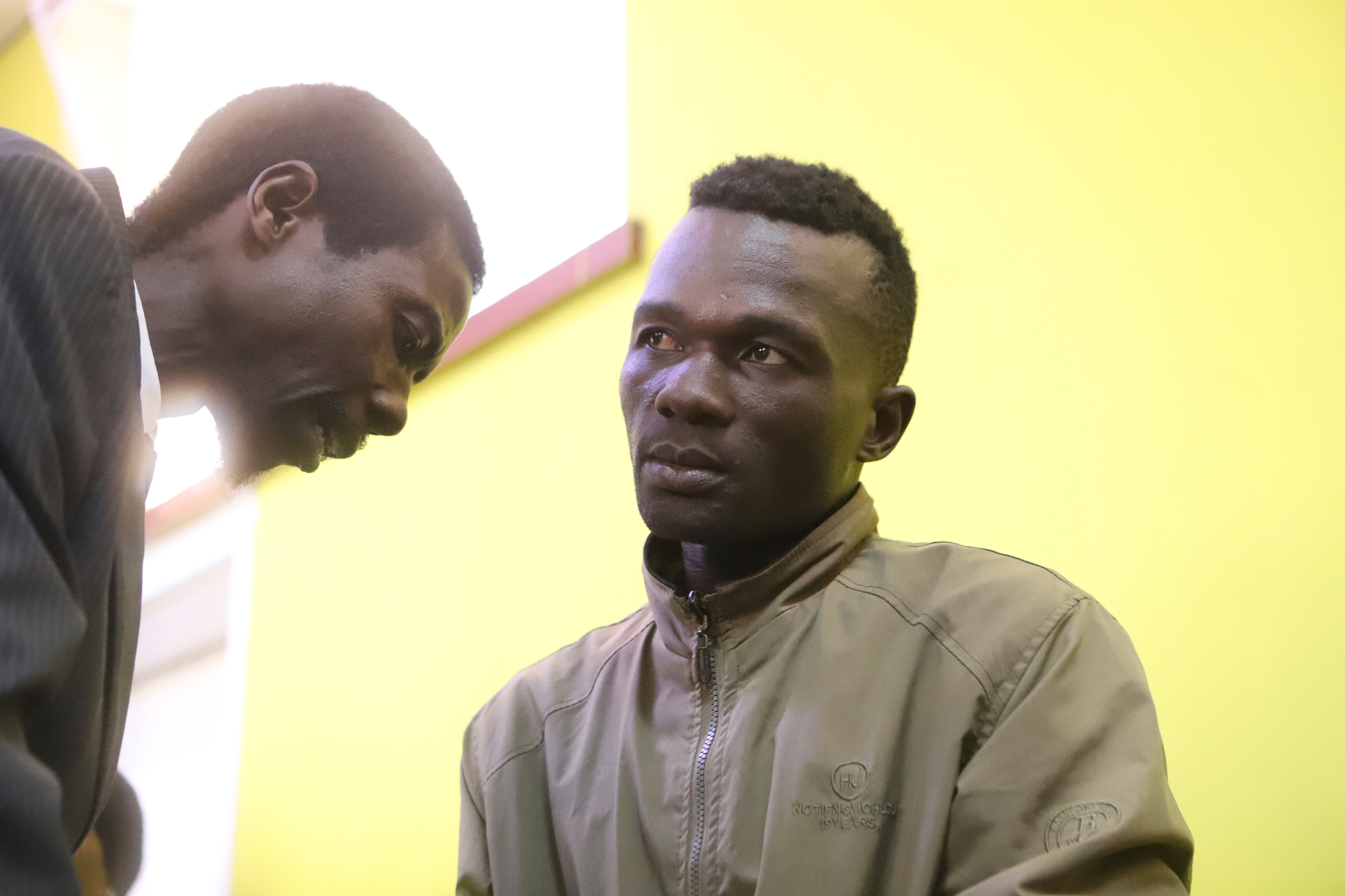 Collins Jumaisi Khalusha, right, confers with his lawyer, JonMaina Ndegwa, left, in court in Nairobi, Kenya, Tuesday, July 16, 2024