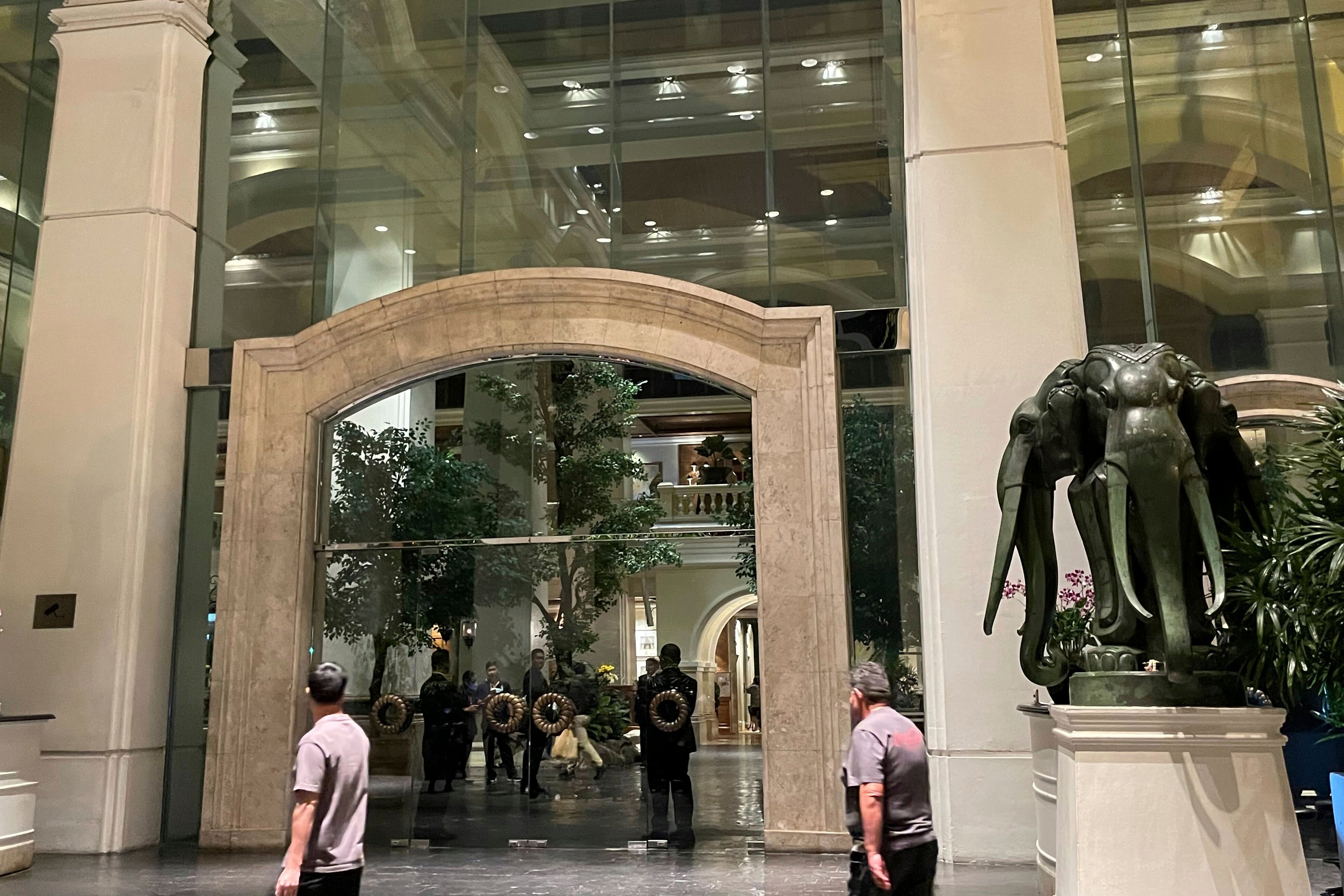 Staff stand in the lobby of a hotel where a number of people were found dead in Bangkok, Thailand, Tuesday, July 16