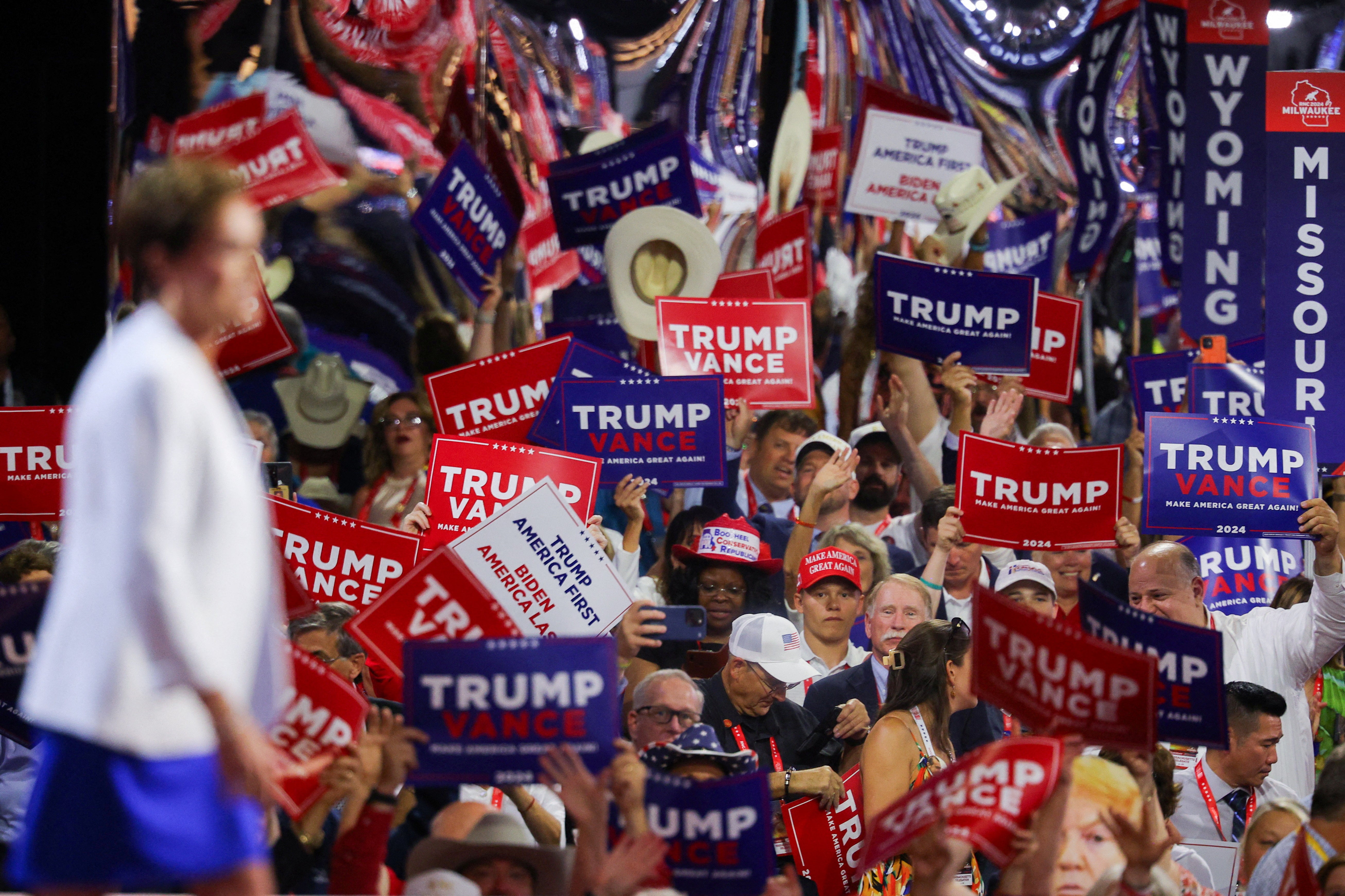 Senate candidate Kari Lake walks in front of signs supporting Republican presidential nominee and former U.S. President Donald Trump and Republican vice presidential nominee JD Vance on Day 2 of the Republican National Convention. Trump called Lake’s campaign and supporters to endorse her the day before the state’s primary elections