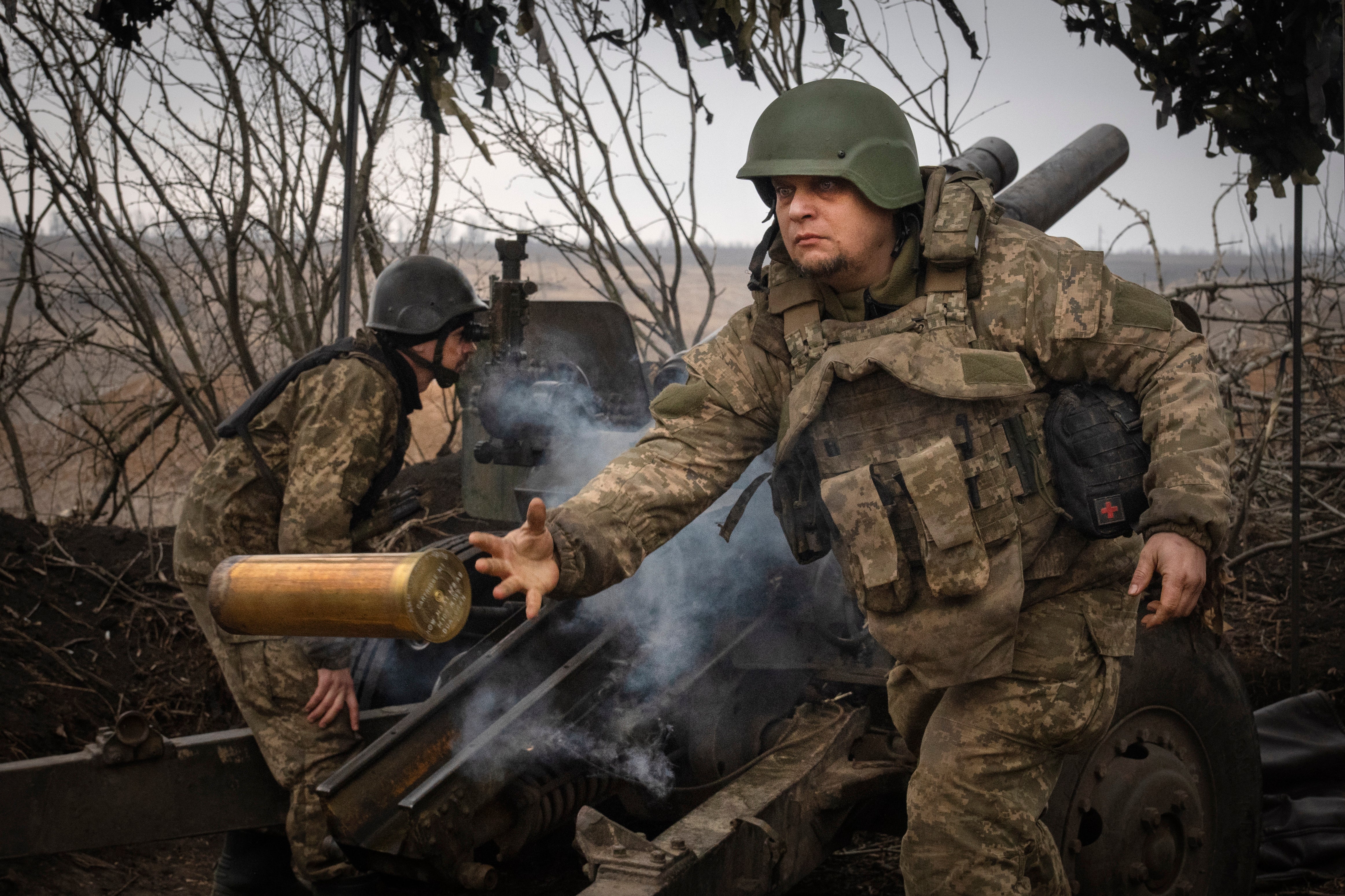 Ukrainian soldiers fire towards Russian positions at the frontline near Avdiivka in the Donetsk region in March