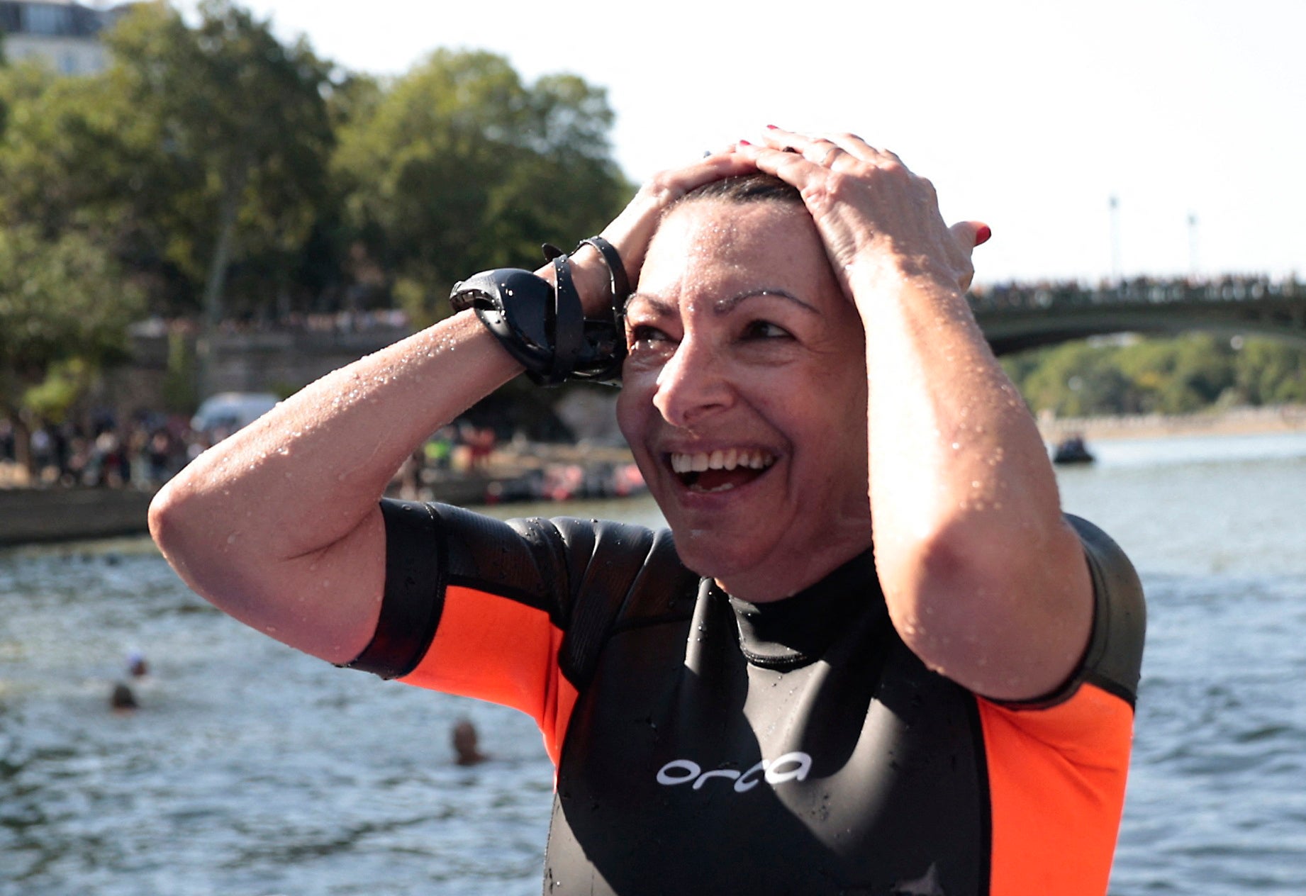 The mayor of Paris, Anne Hidalgo, emerges from the Seine after taking a plunge