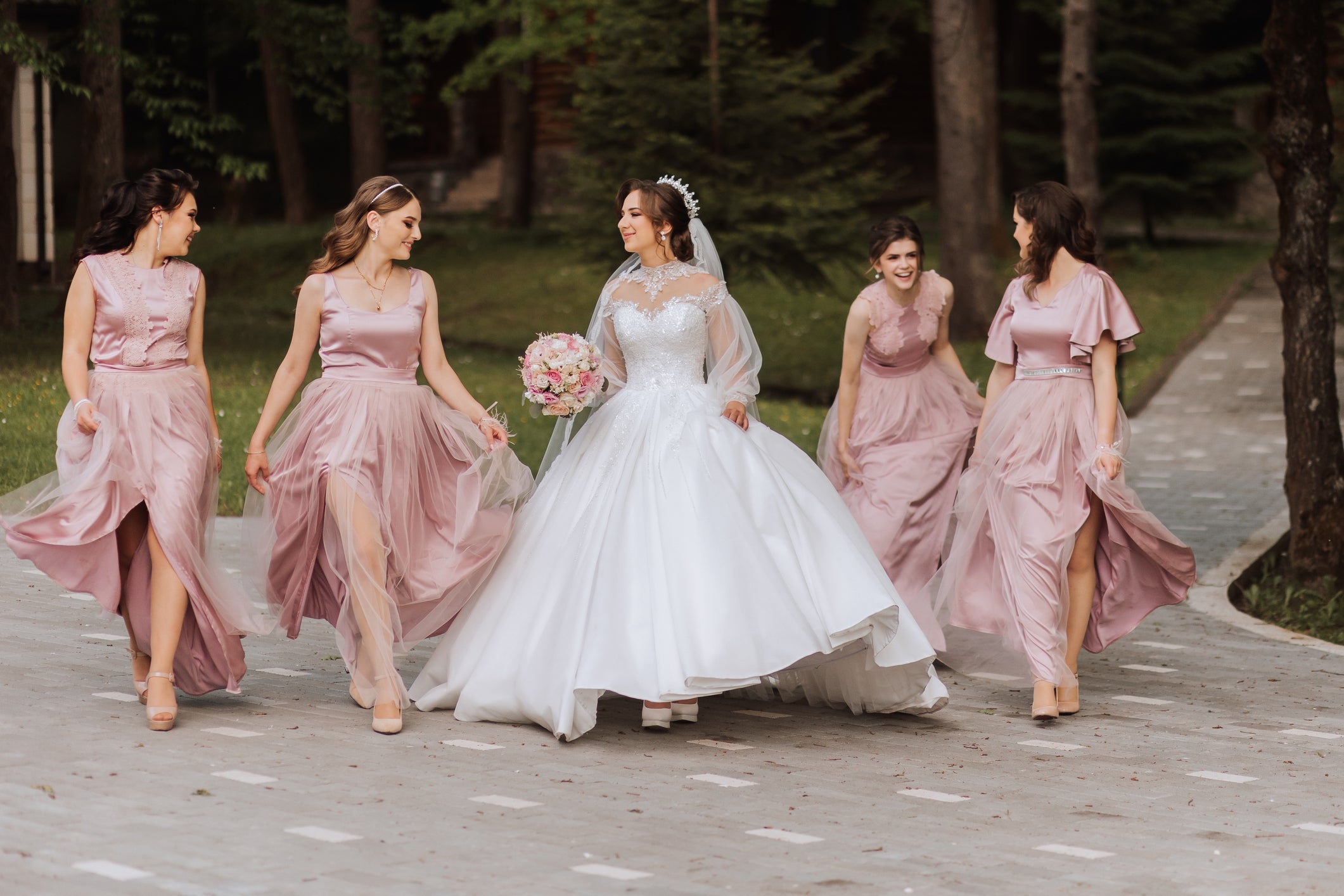 A bride with her bridesmaids. Much of the hard work that goes into planning a wedding comes long before the bride walks down the aisle