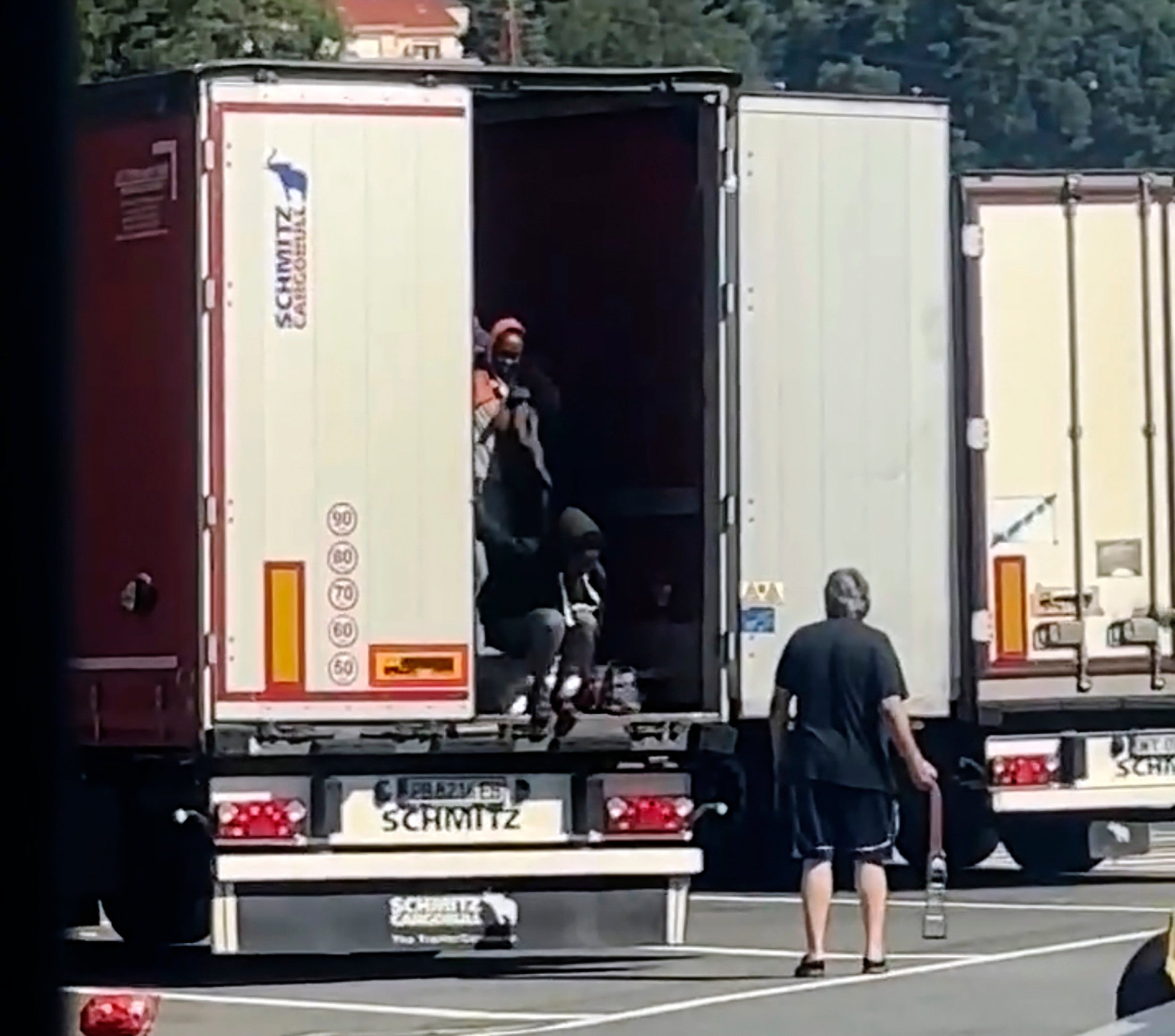 In this frame grab taken from a truck driver strikes female migrants with the hardware end of a cargo strap as they exited from the back of his truck at rest stop near the French border in Ventimiglia, Monday, July 15, 2024