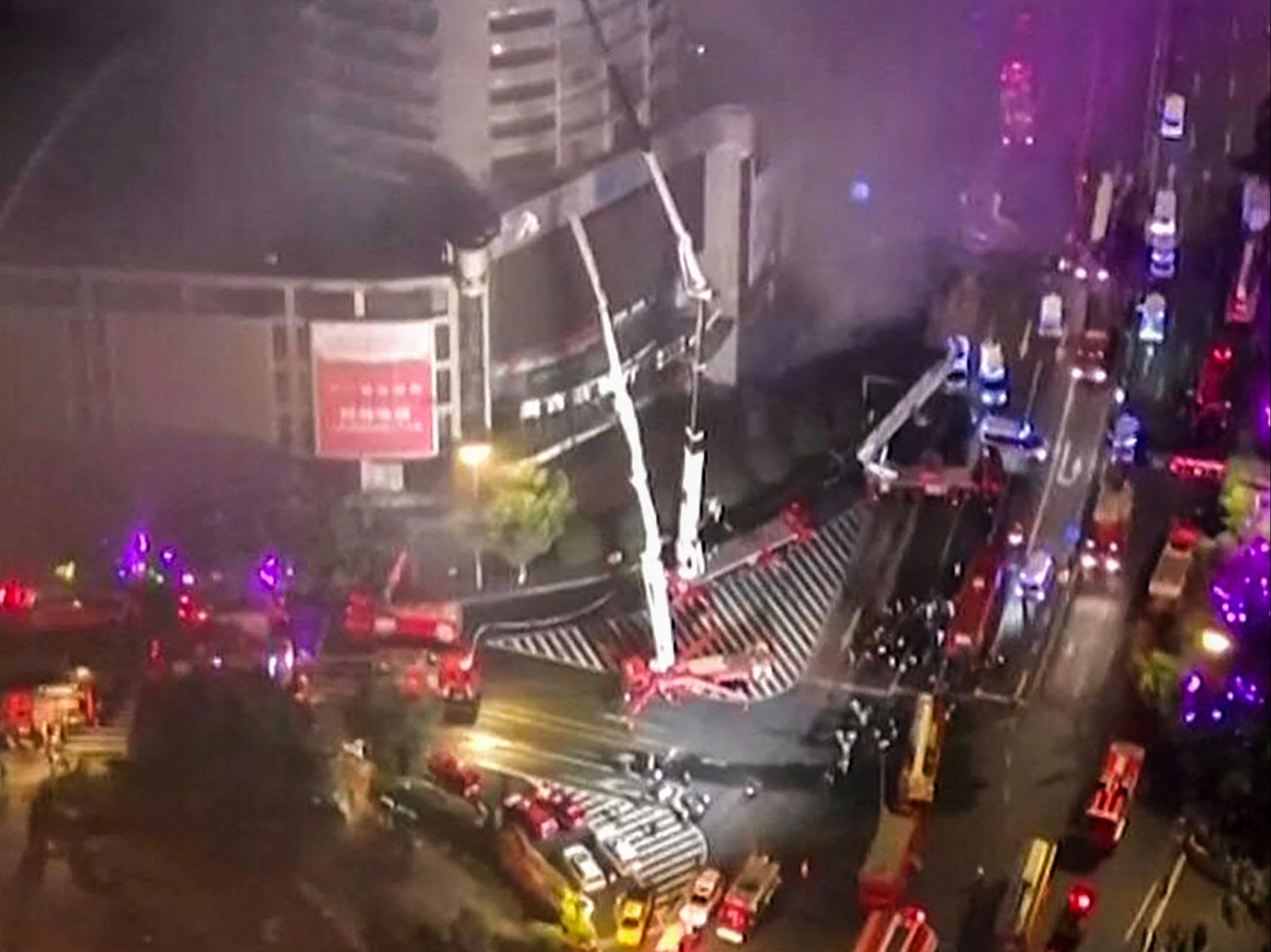 Firefighters extinguishing a fire tearing through a shopping centre in Zigong in China's southwestern Sichuan province