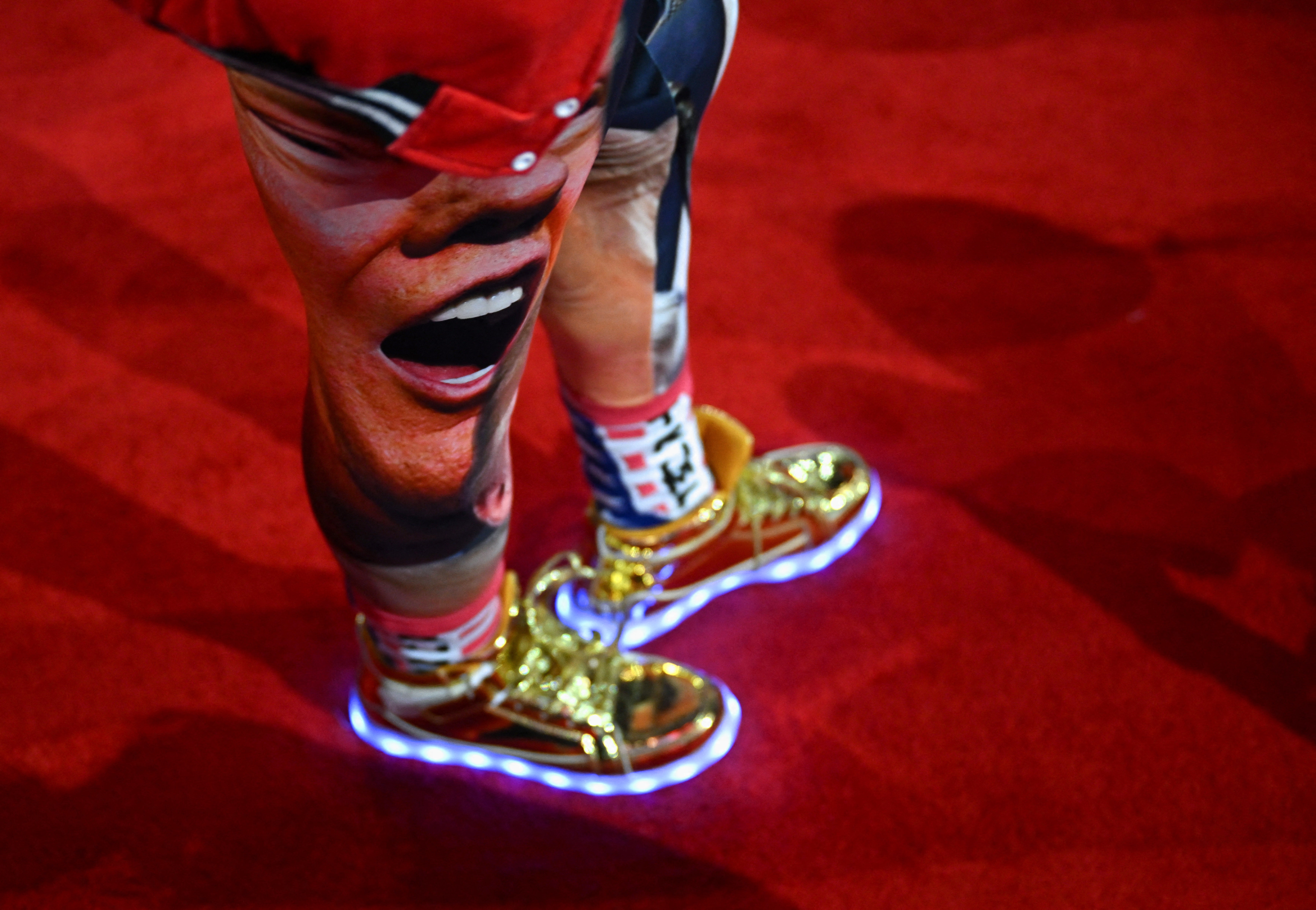 An attendee wearing gold, light-up sneakers. The range was launched by Trump in February, costing $399 a pair. A new limited edition version, referencing the assassination attempt, went on sale at the convention