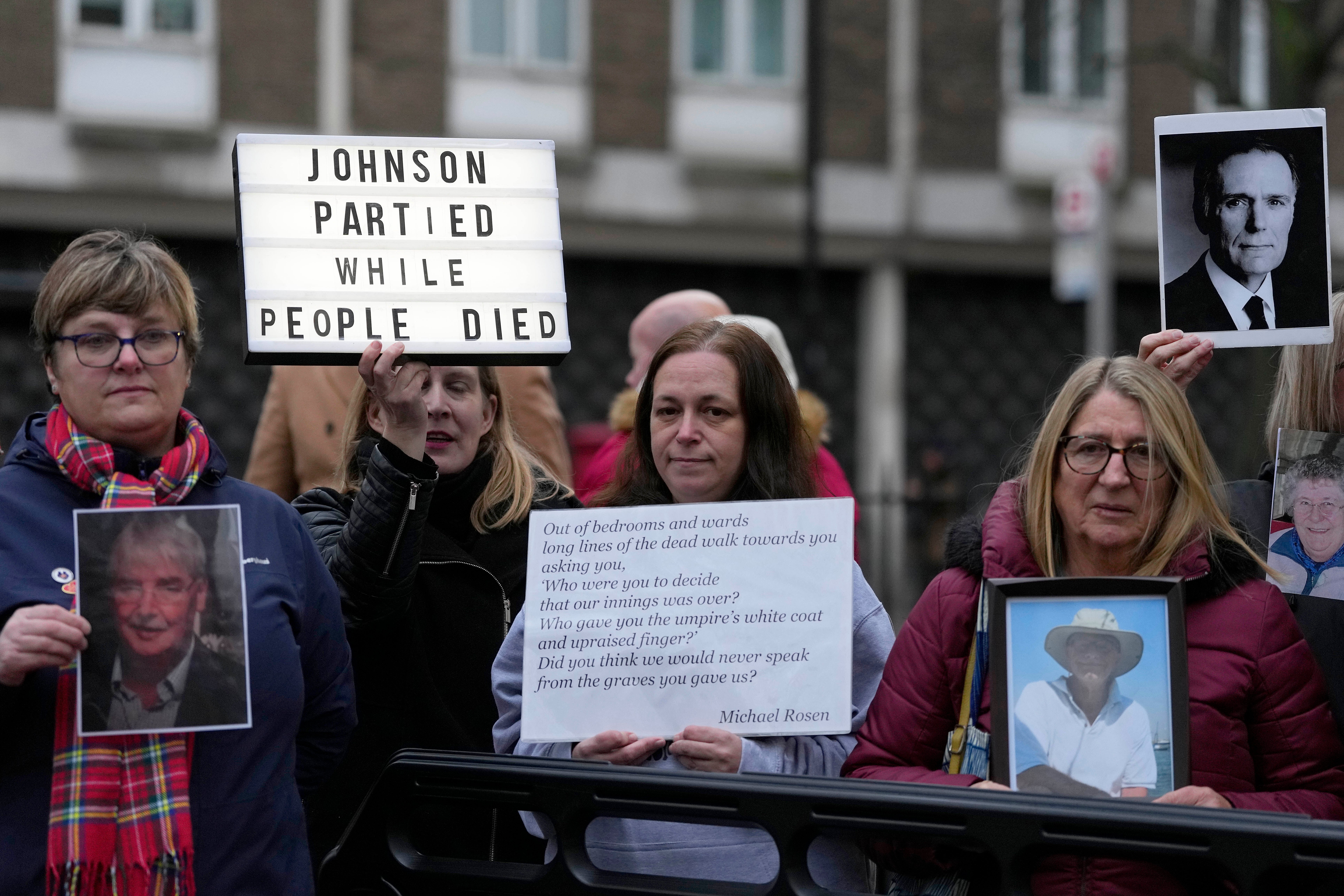 Protesters stand outside Dorland House as Boris Johnson testifies at the Covid inquiry in December 2023