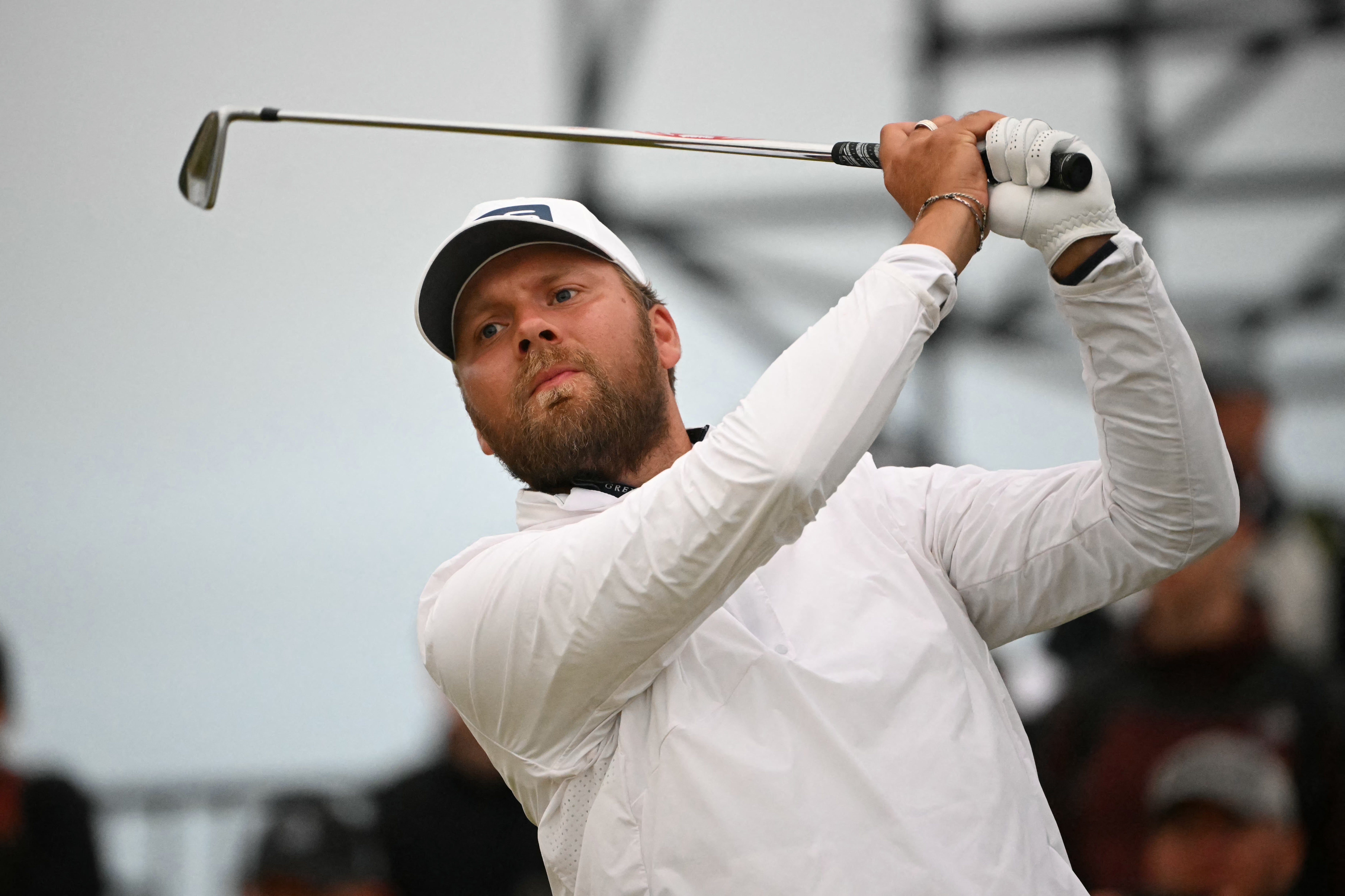 England's Daniel Brown watches his iron shot from the 17th tee