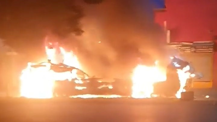 Flames engulf double-decker bus after riot breaks out in Leeds with hundreds on streets