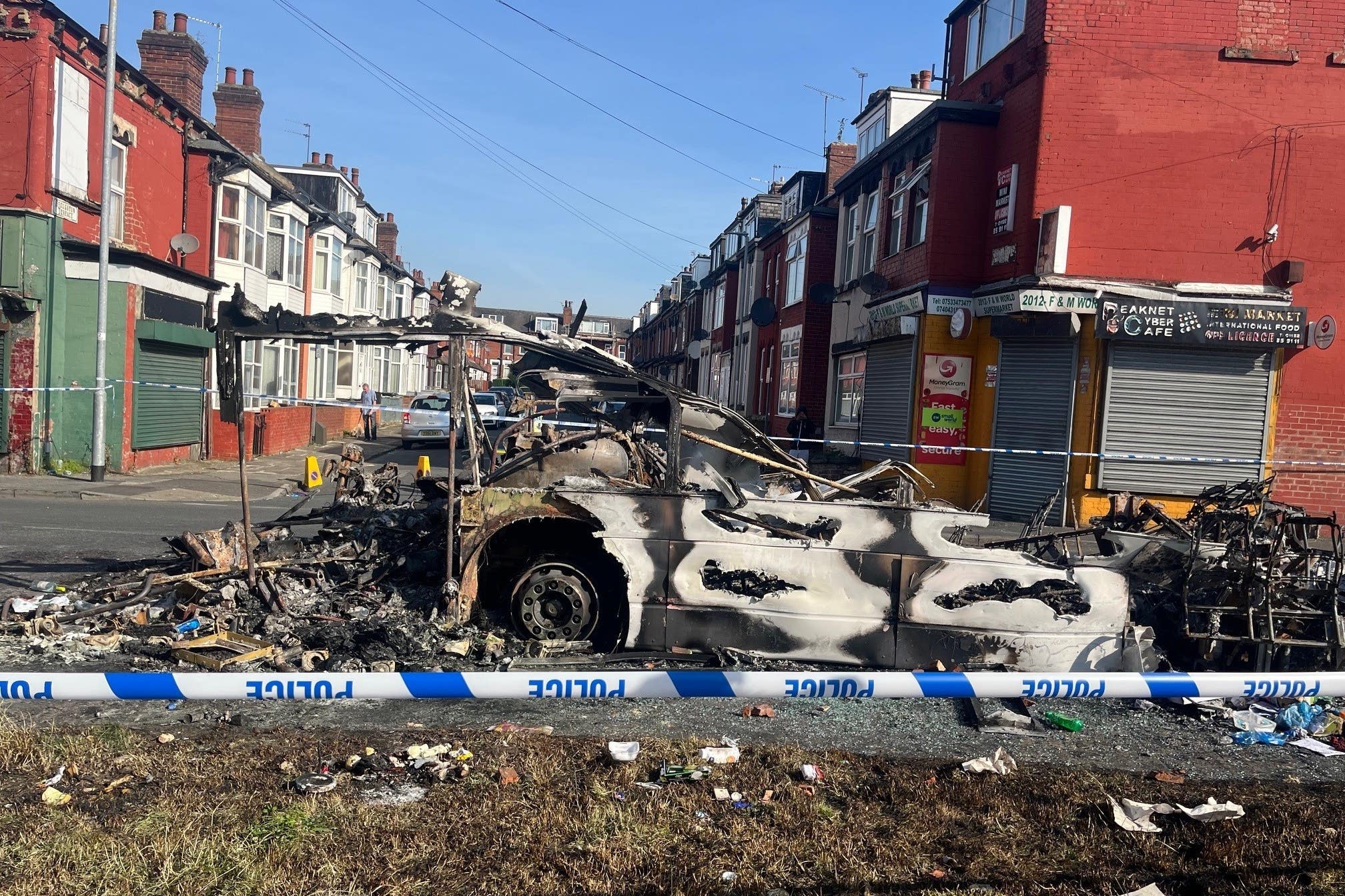 A burnt-out car in the Leeds suburb of Harehills (Katie Dickinson/PA)