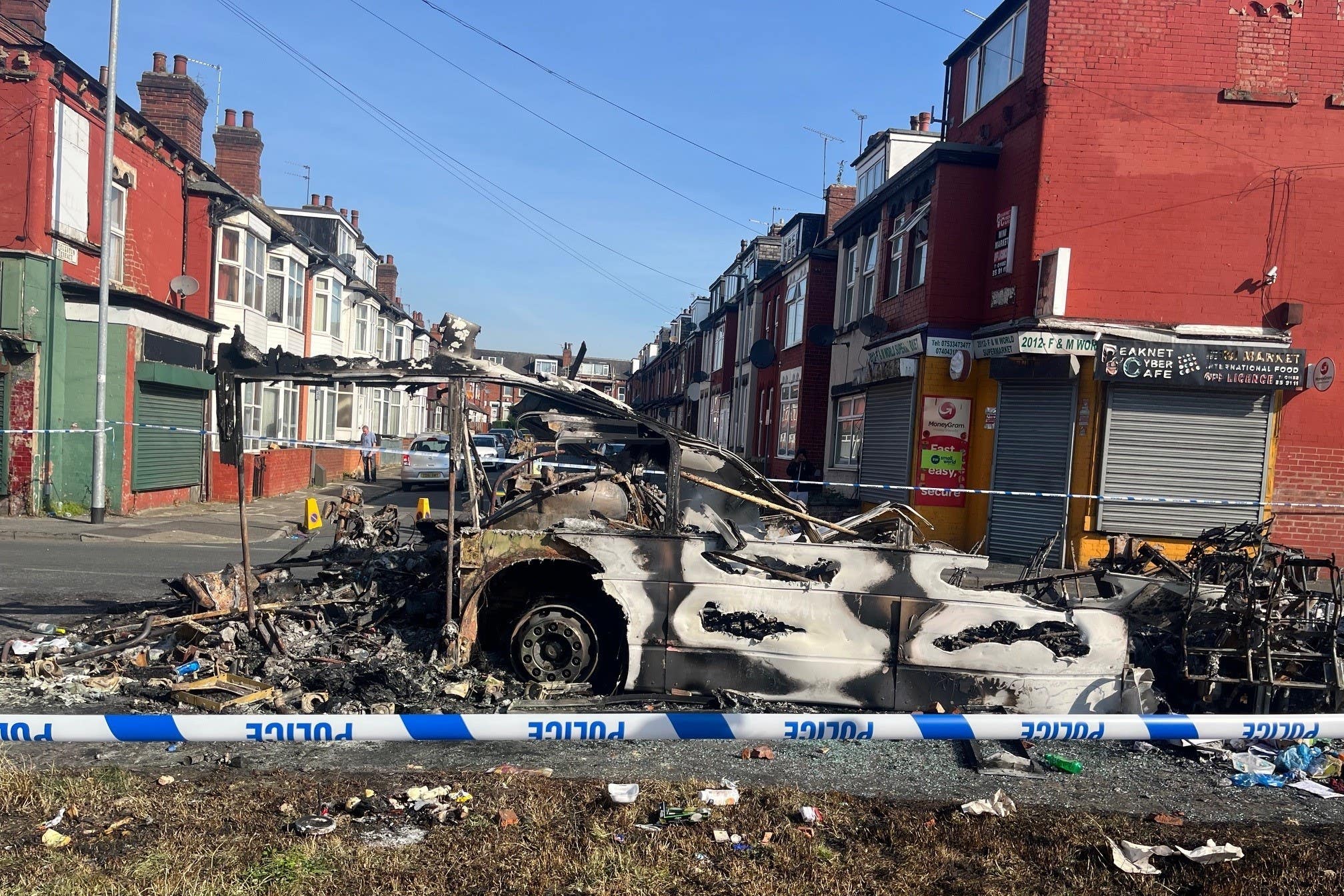 A burnt out car in the Leeds suburb of Harehills