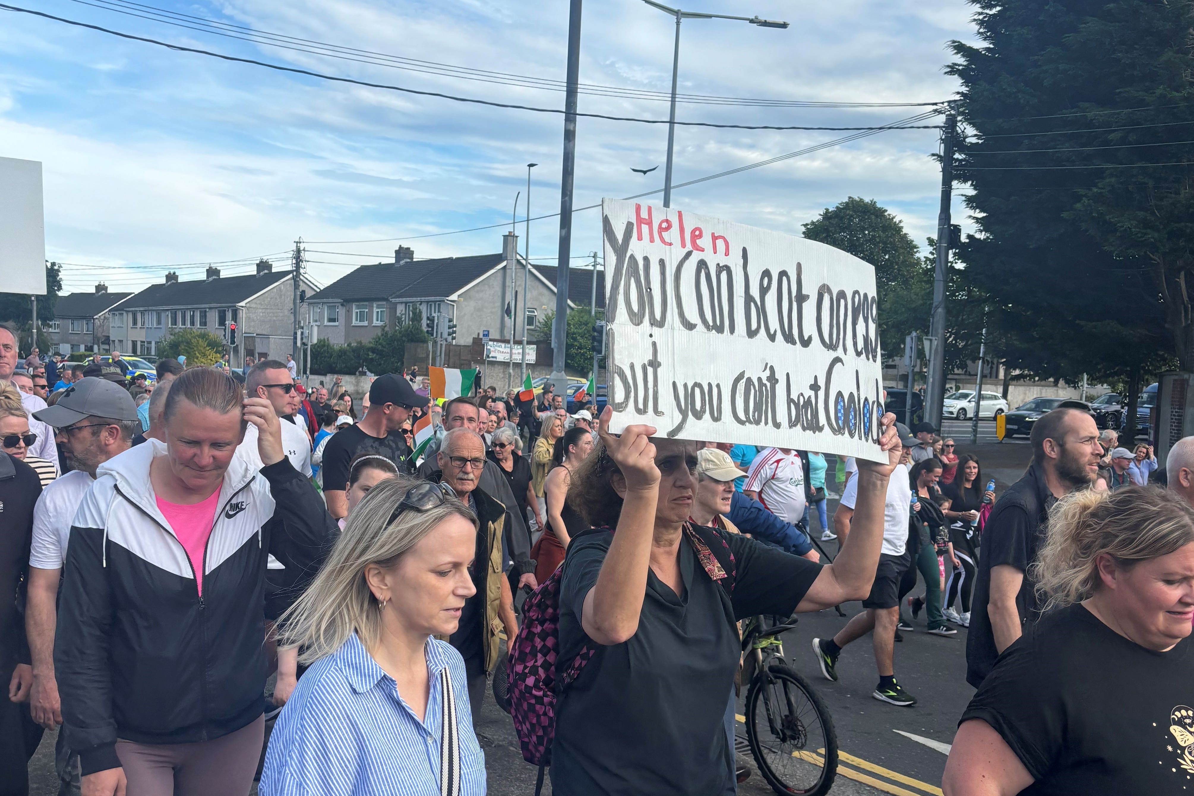 People take part in a demonstration in Coolock, north Dublin (Cate McCurry/PA)