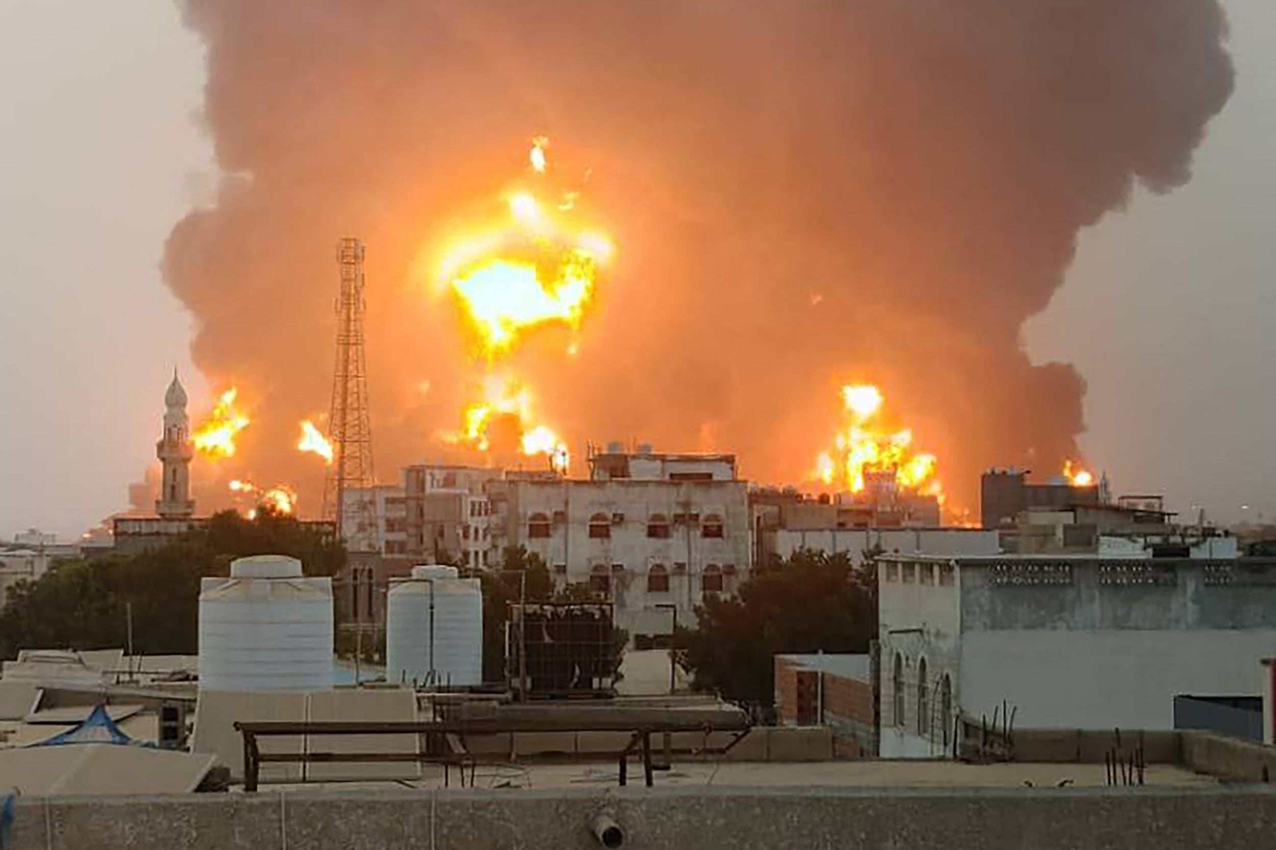 A handout picture obtained from Yemen's Huthi Ansarullah Media Center shows a huge column of fire erupting following reported strikes in the Yemeni rebel-held port city of Hodeida opn July 20