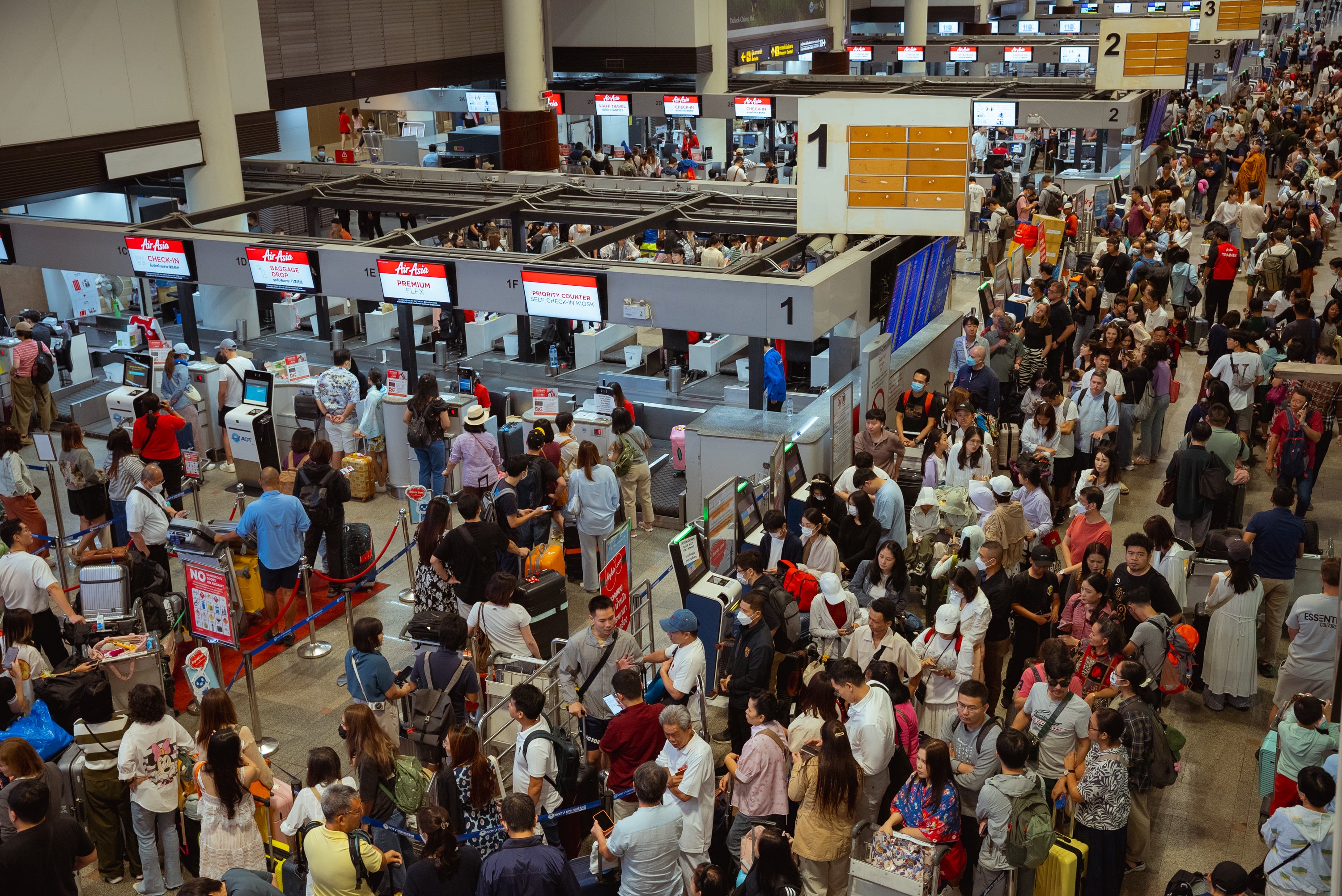 Queues of passengers at the Air Asia check-in counters at Don Mueang Airport international departures on 20 July 20 2024 in Bangkok. The US Department of Transportation announced it’ll investigate Delta Airlines over its handling of the issue