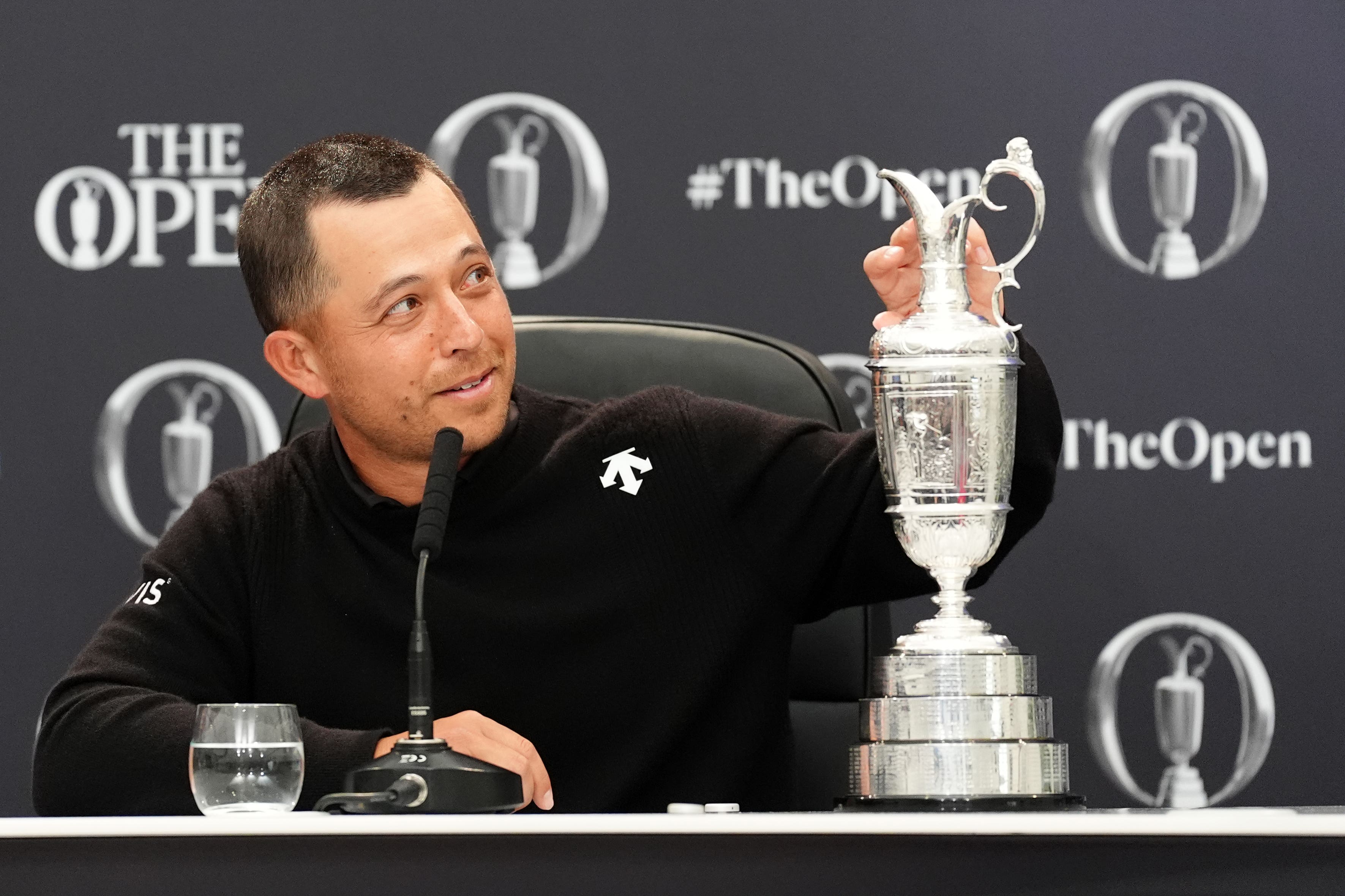 Xander Schauffele gave his dad Stefan the honour of the first drink from the Claret Jug (Zac Goodwin/PA)