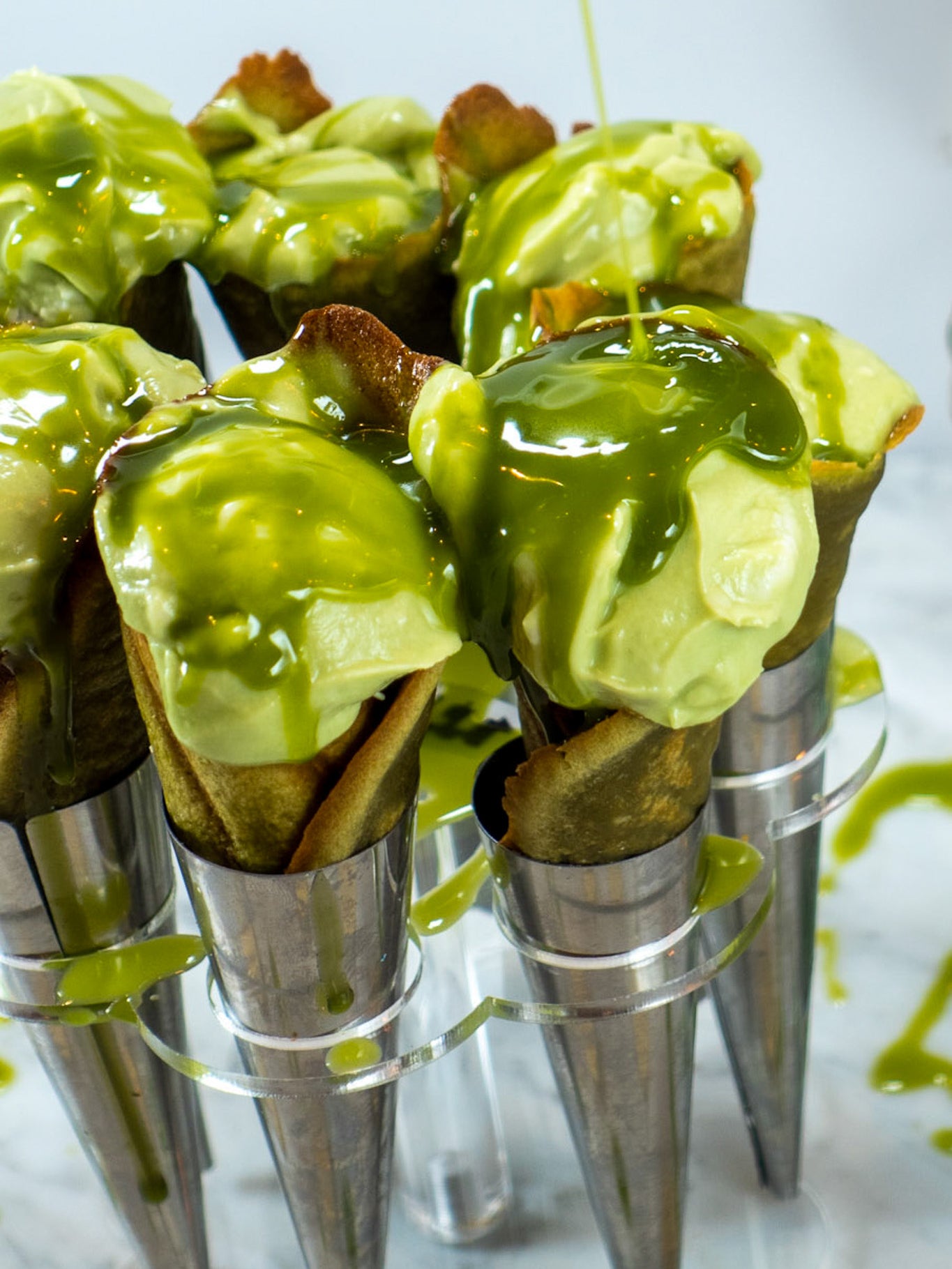 Homemade vegan matcha ice cream served in delicate matcha cones, offering a refreshing and elegant summer dessert