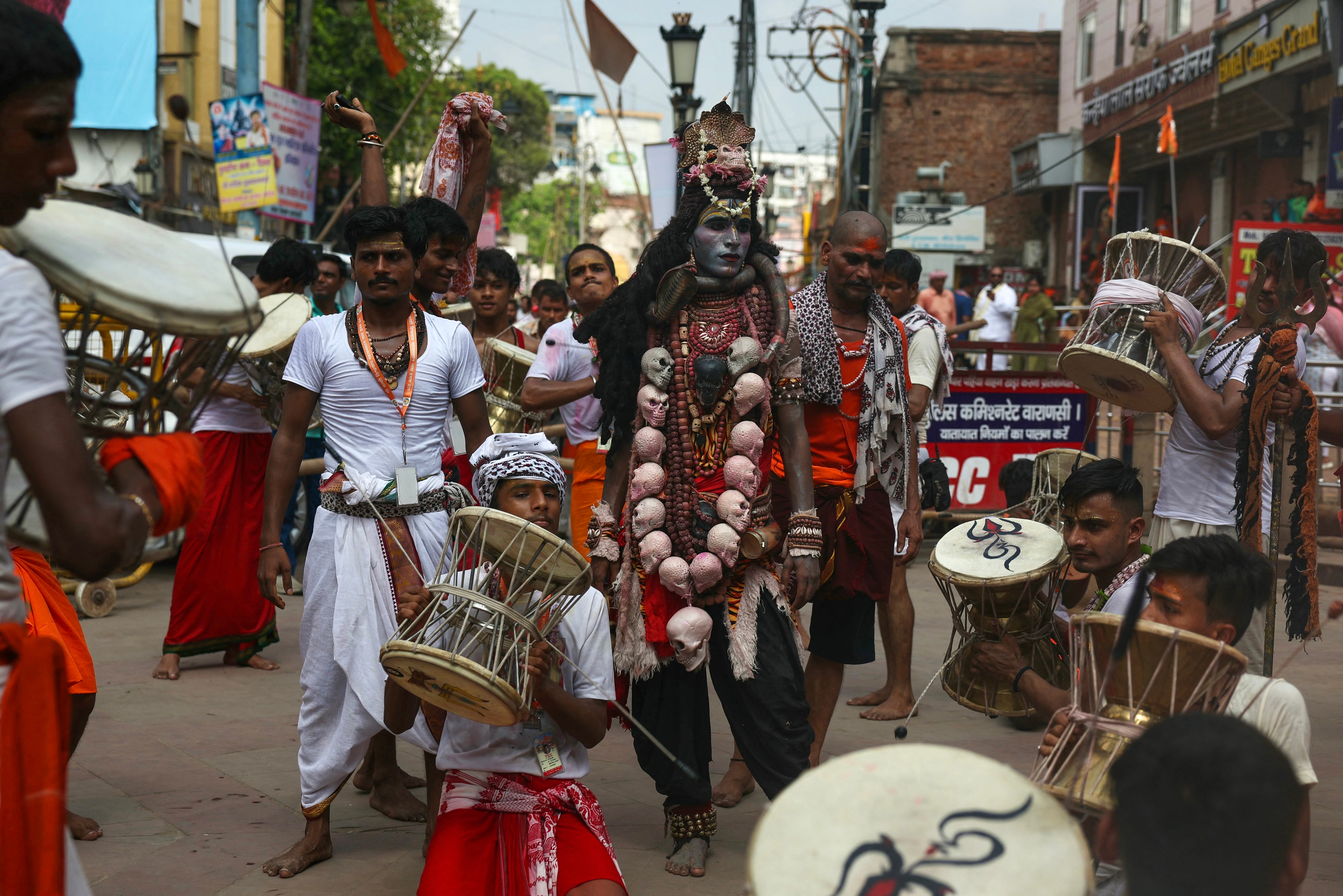 Hindus play drums as they take part in a procession to celebrate a festival dedicated to god Shiva