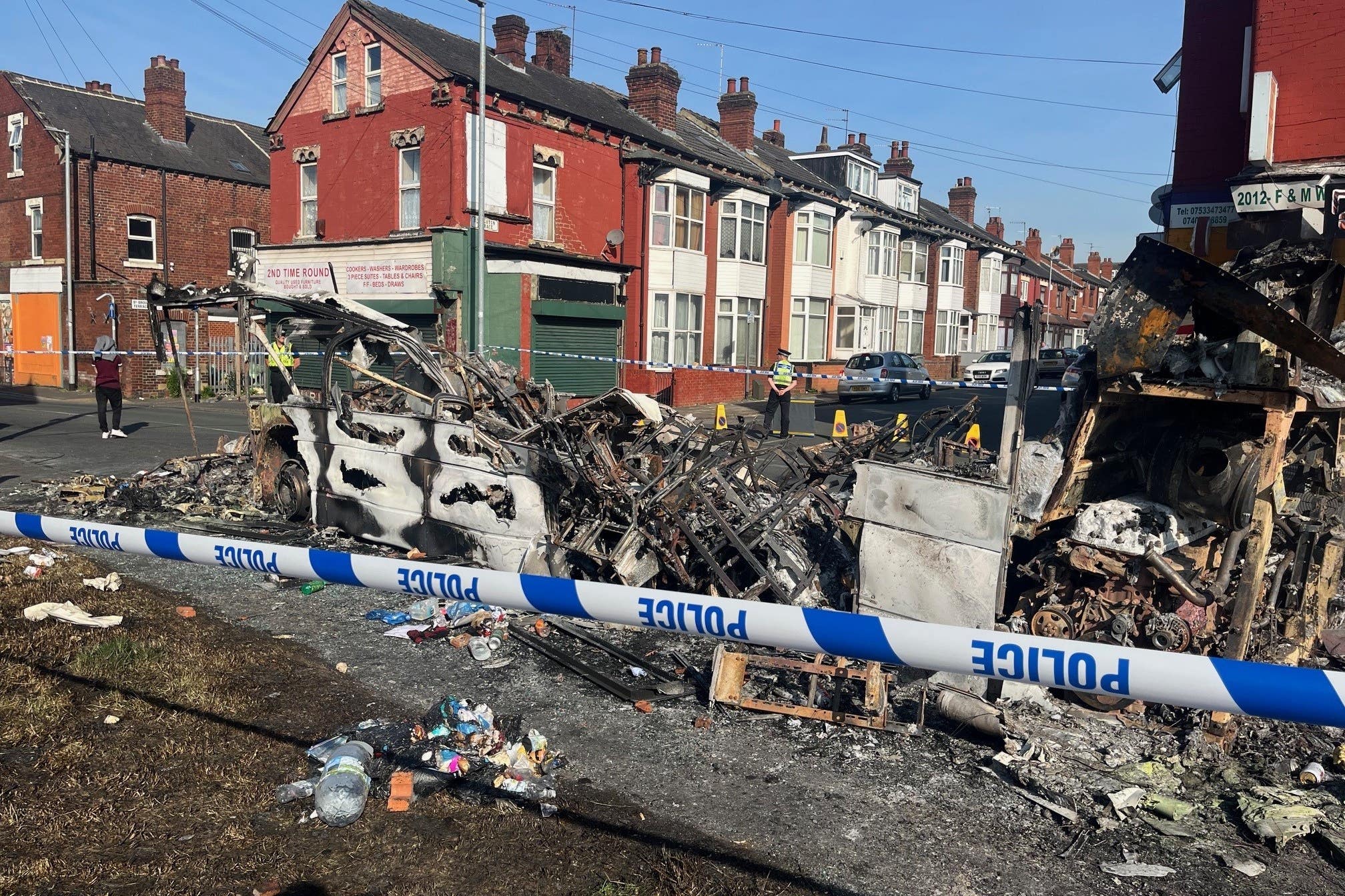 A burnt-out vehicle in the Leeds suburb of Harehills after disorder (Katie Dickinson/PA)