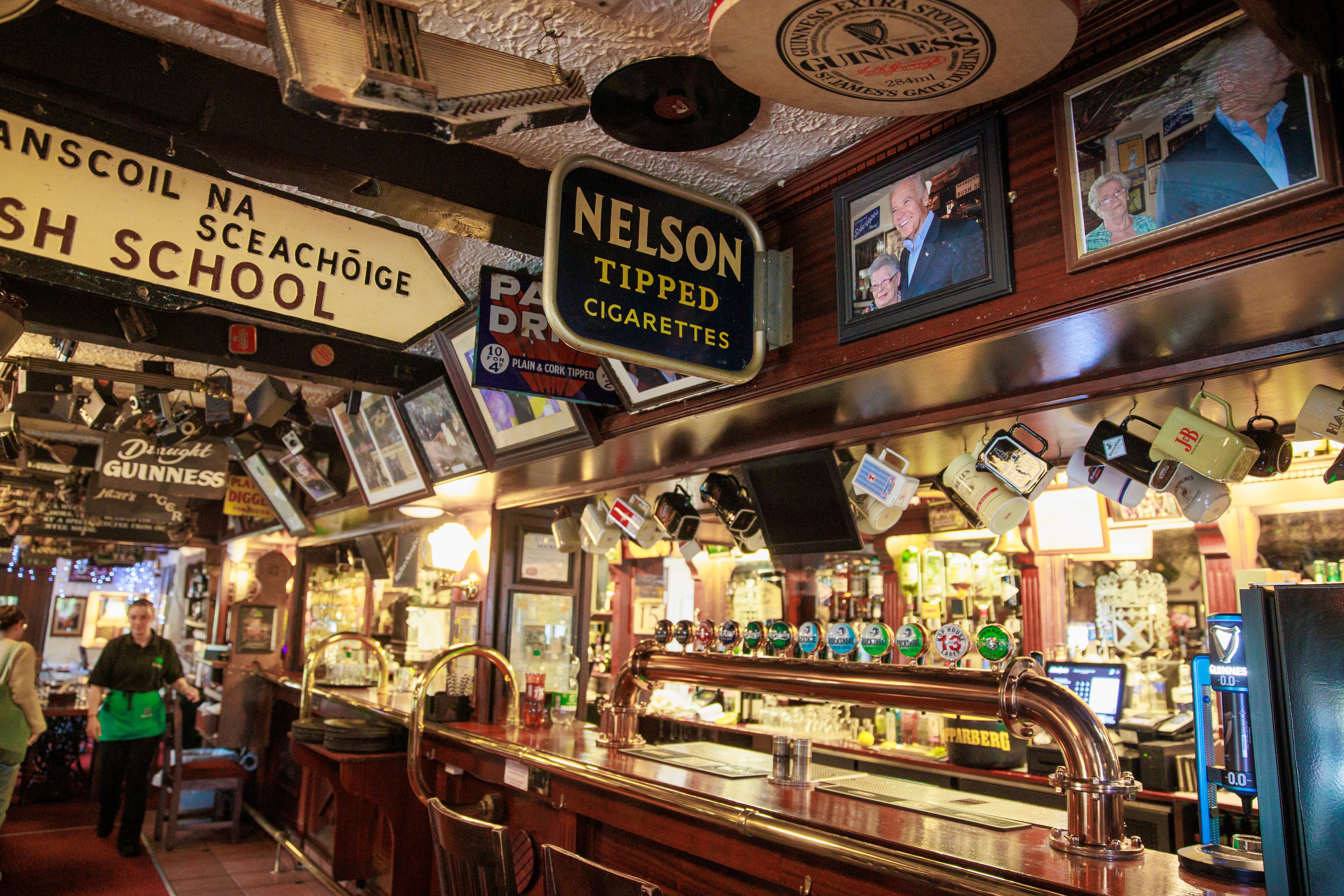 Image of President Joe Biden during a visit as Vice President, hangs above the bar