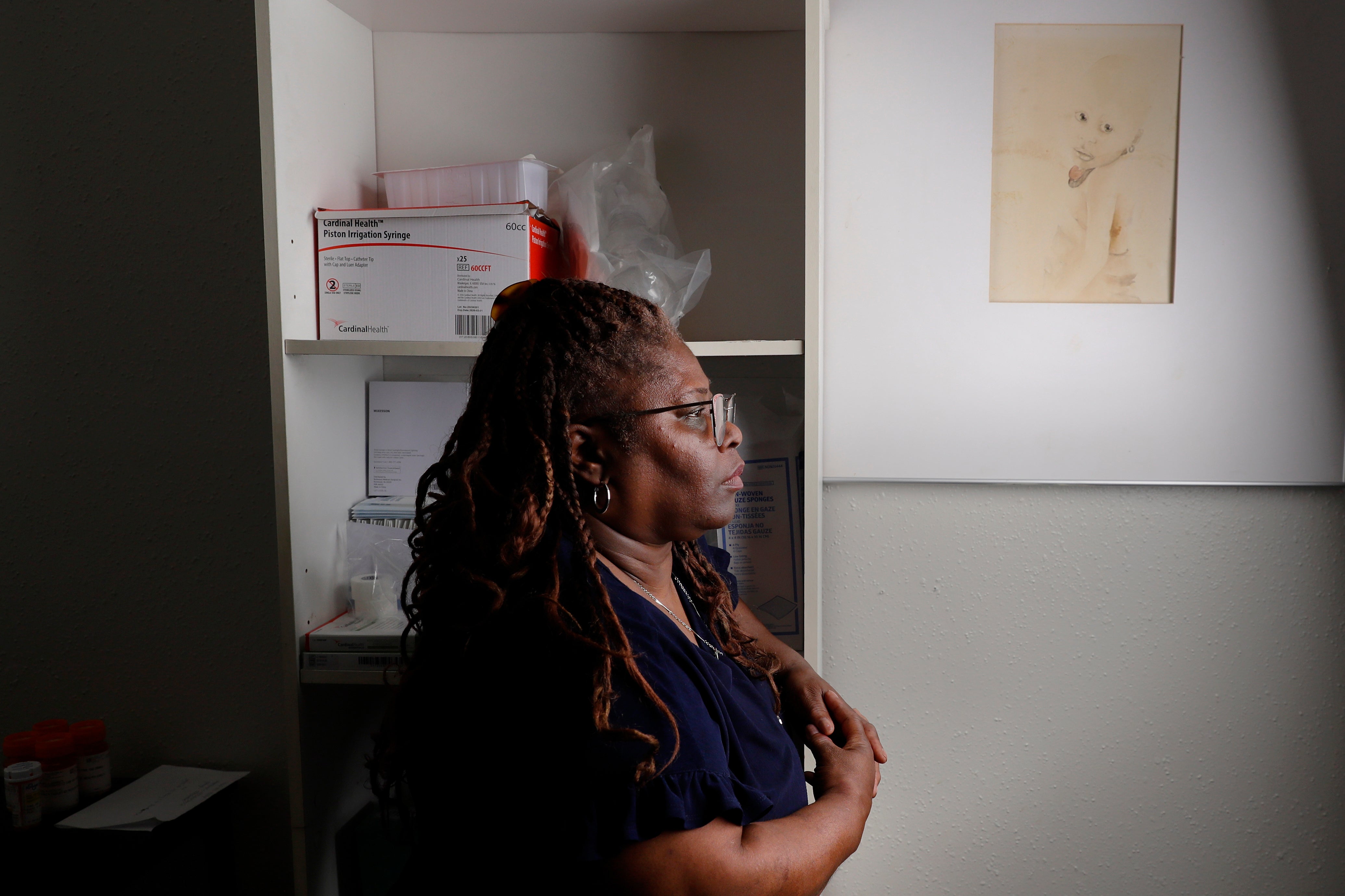 Janet Jarrett standing next to a sketch drawn by her sister, Pamela Jarrett, in Pamela's bedroom in the house they shared together in Spring, Texas. Describing her sister as “funny” and “very sassy,” Janet told the station that she would also remember her sister as being very big on fashion, as she laid out a pearly white dress that Pamela would be buried in