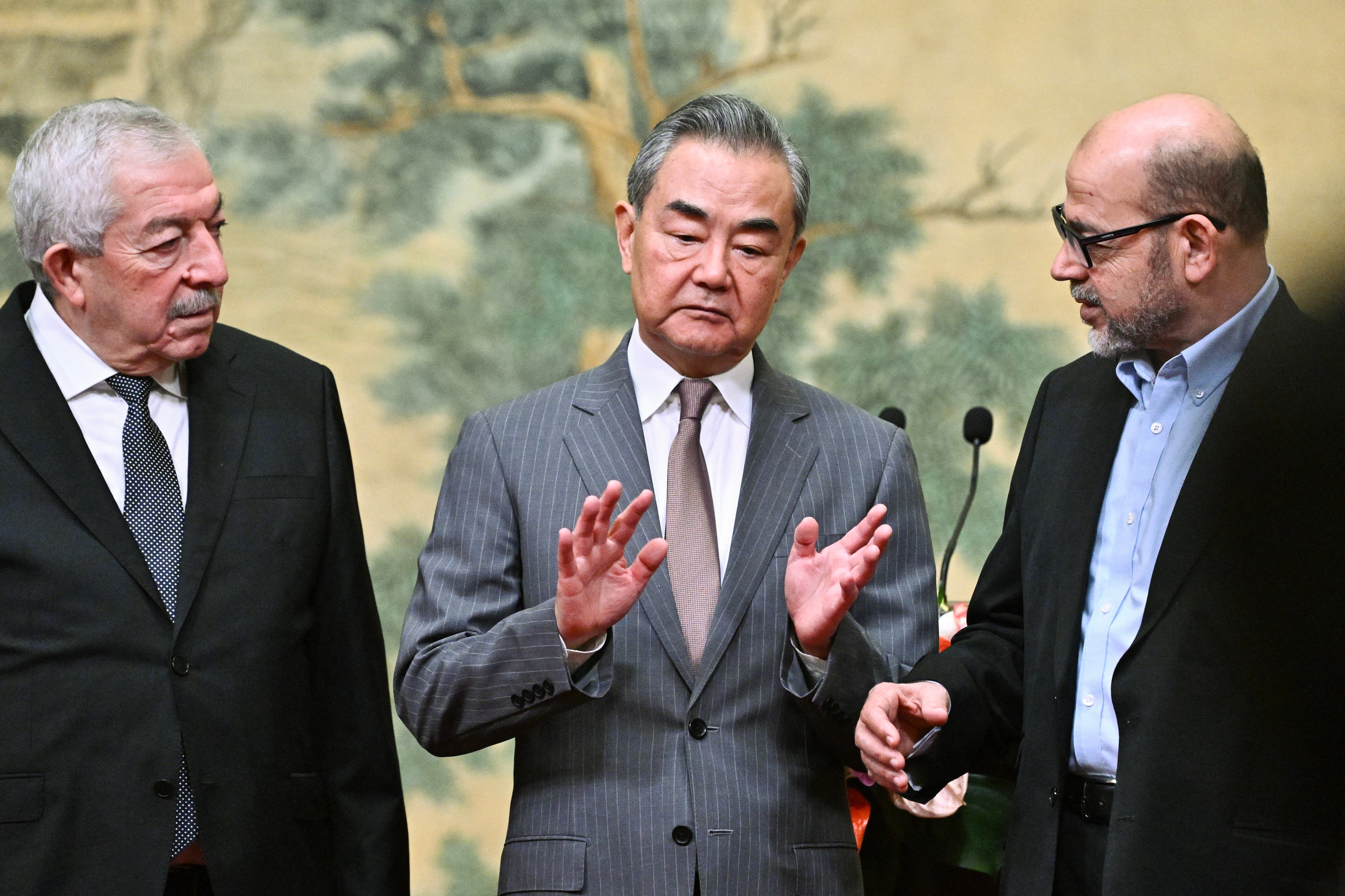 Mahmoud al-Aloul, vice-chair of Fatah, China’s foreign minister Wang Yi, and Mousa Abu Marzouk, senior member of Hamas, attend an event at the Diaoyutai State Guesthouse in Beijing