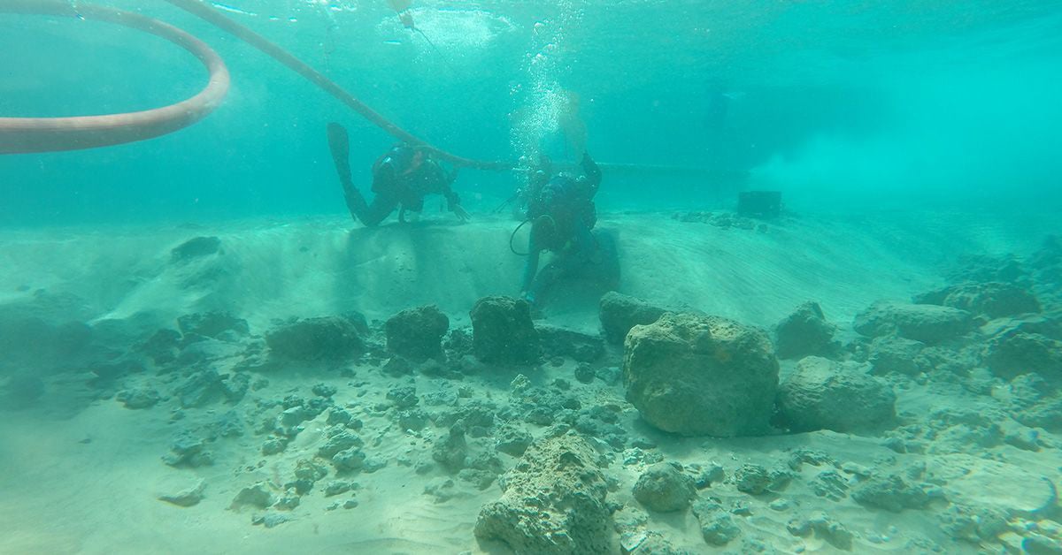 Divers on a research team examine architectural remains at the underwater village of Habonim North, off Israel’s Carmel Coast.