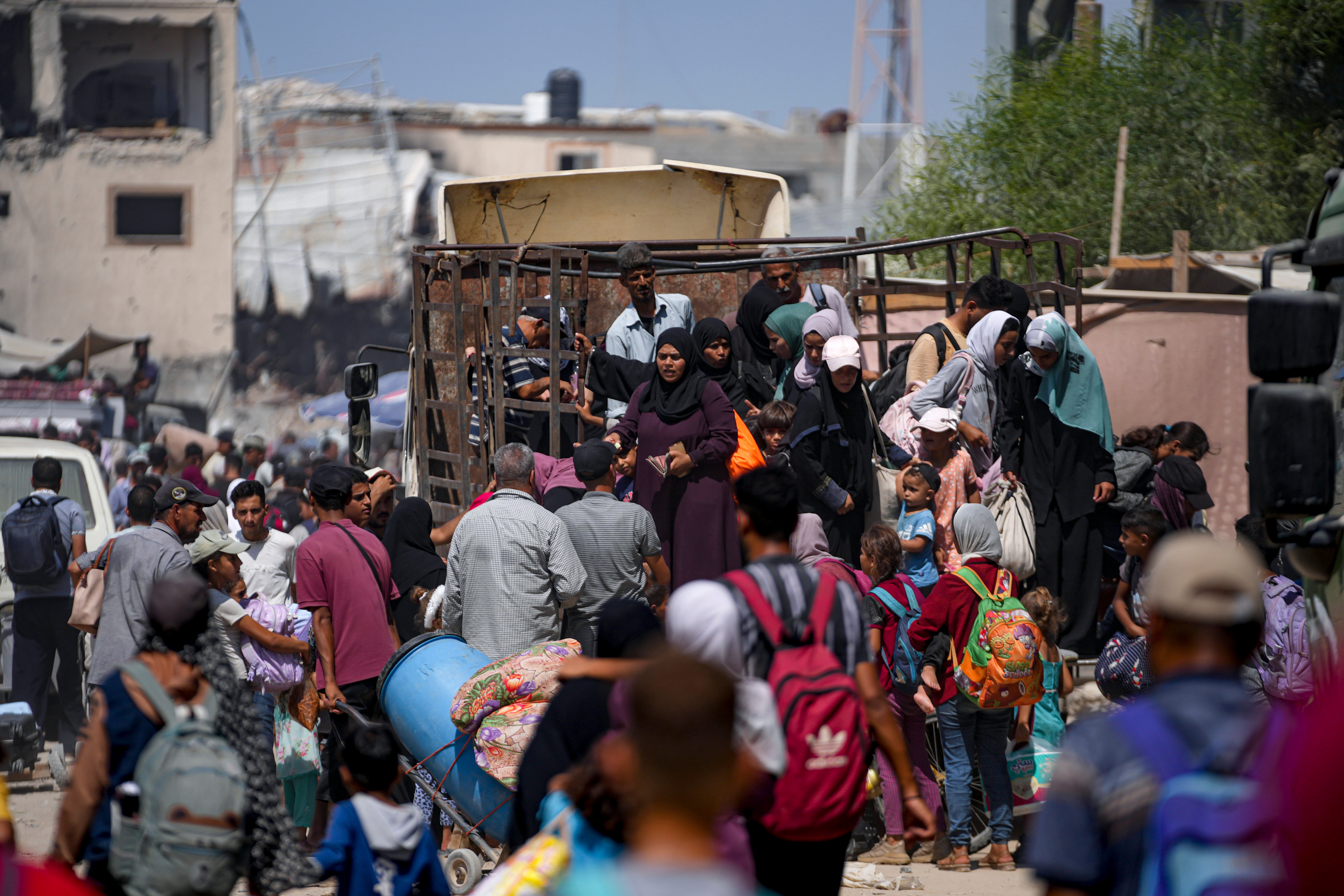 Palestinians displaced by the Israeli air and ground offensive on the Gaza Strip flee from parts of Khan Younis