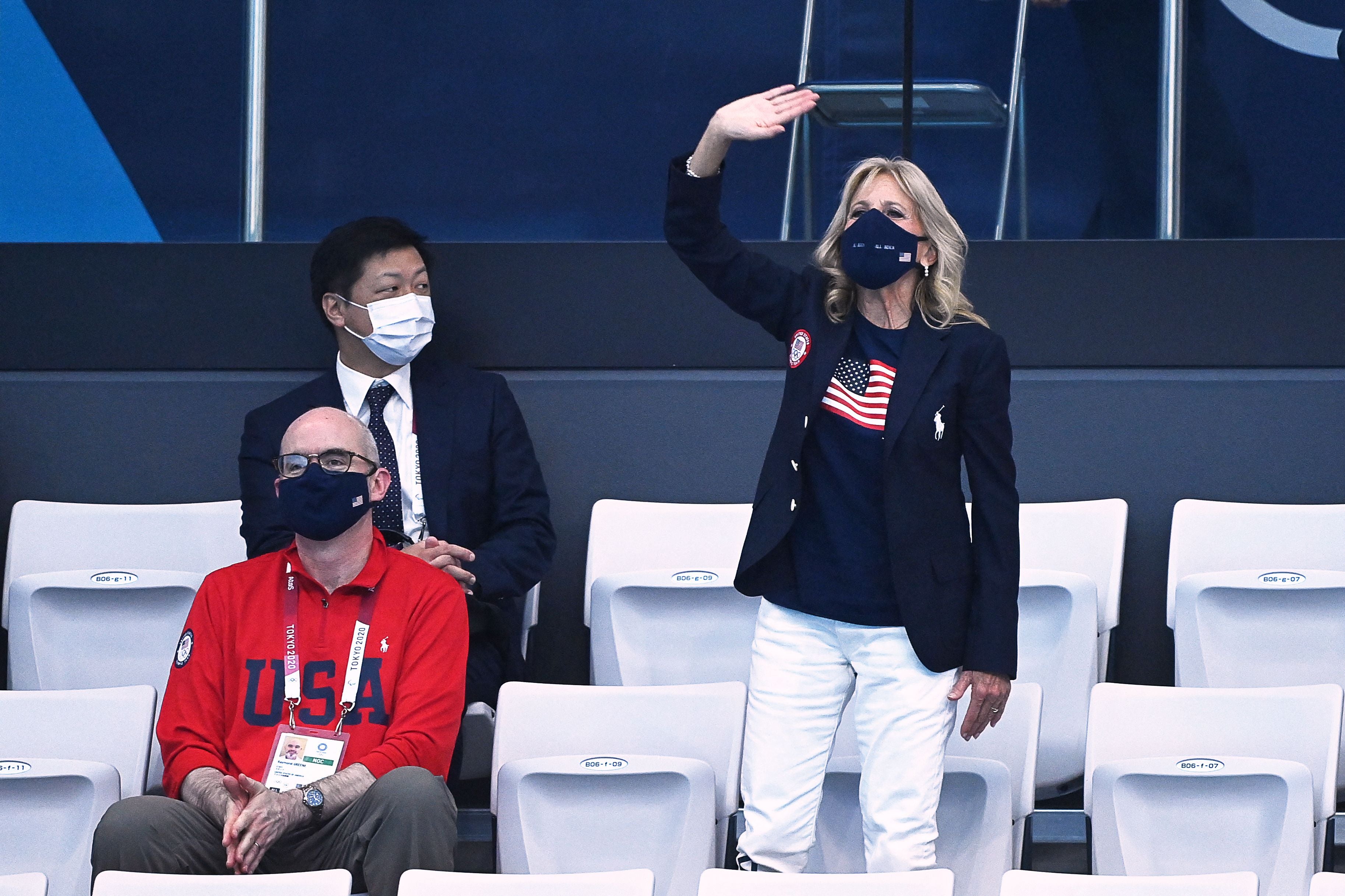 Jill Biden waves as she attends a swimming event during the Tokyo 2020 Olympic Games at the Tokyo Aquatics Centre in Tokyo on July 24, 2021