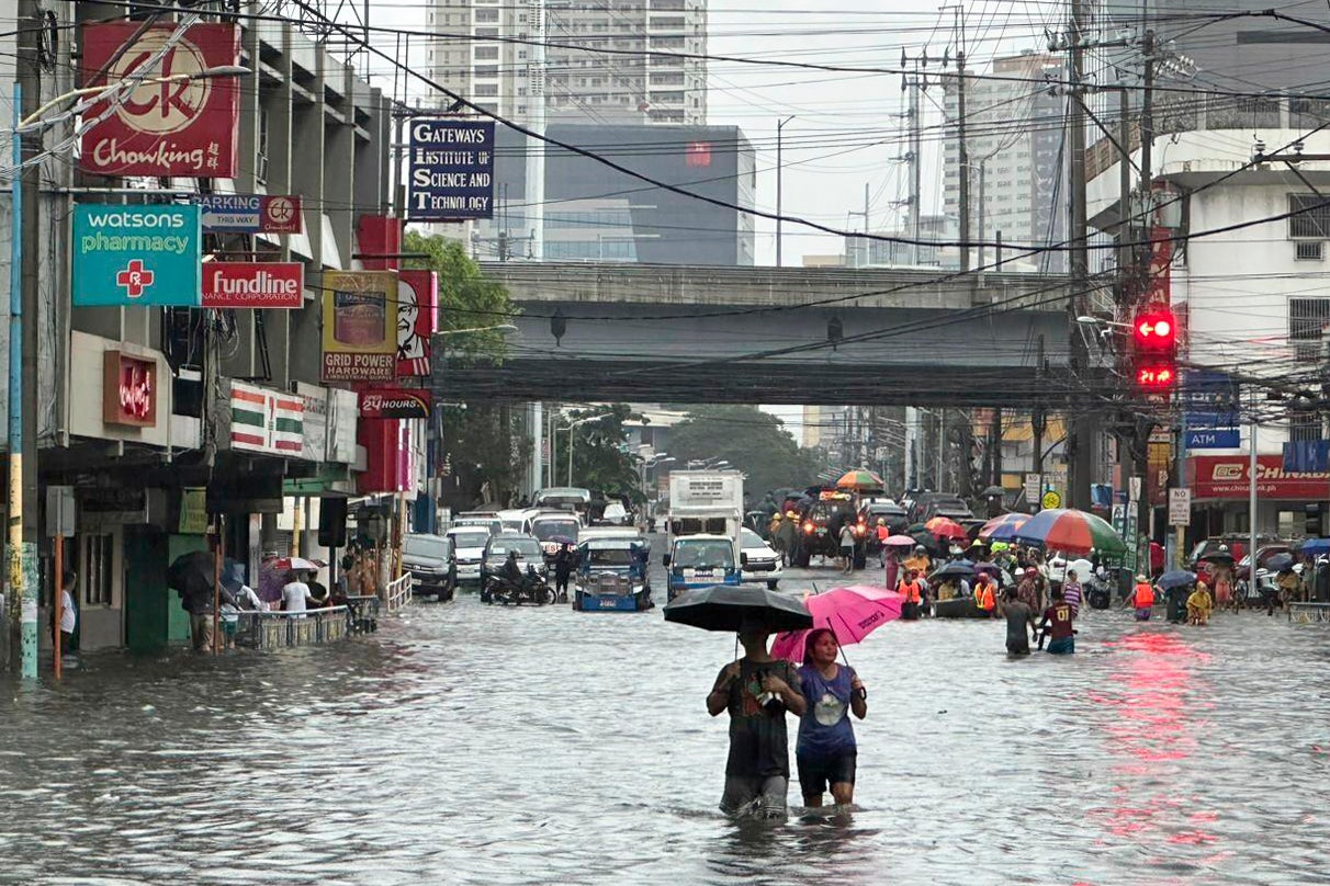 Streets flood from monsoon rains worsened by offshore typhoon Gaemi