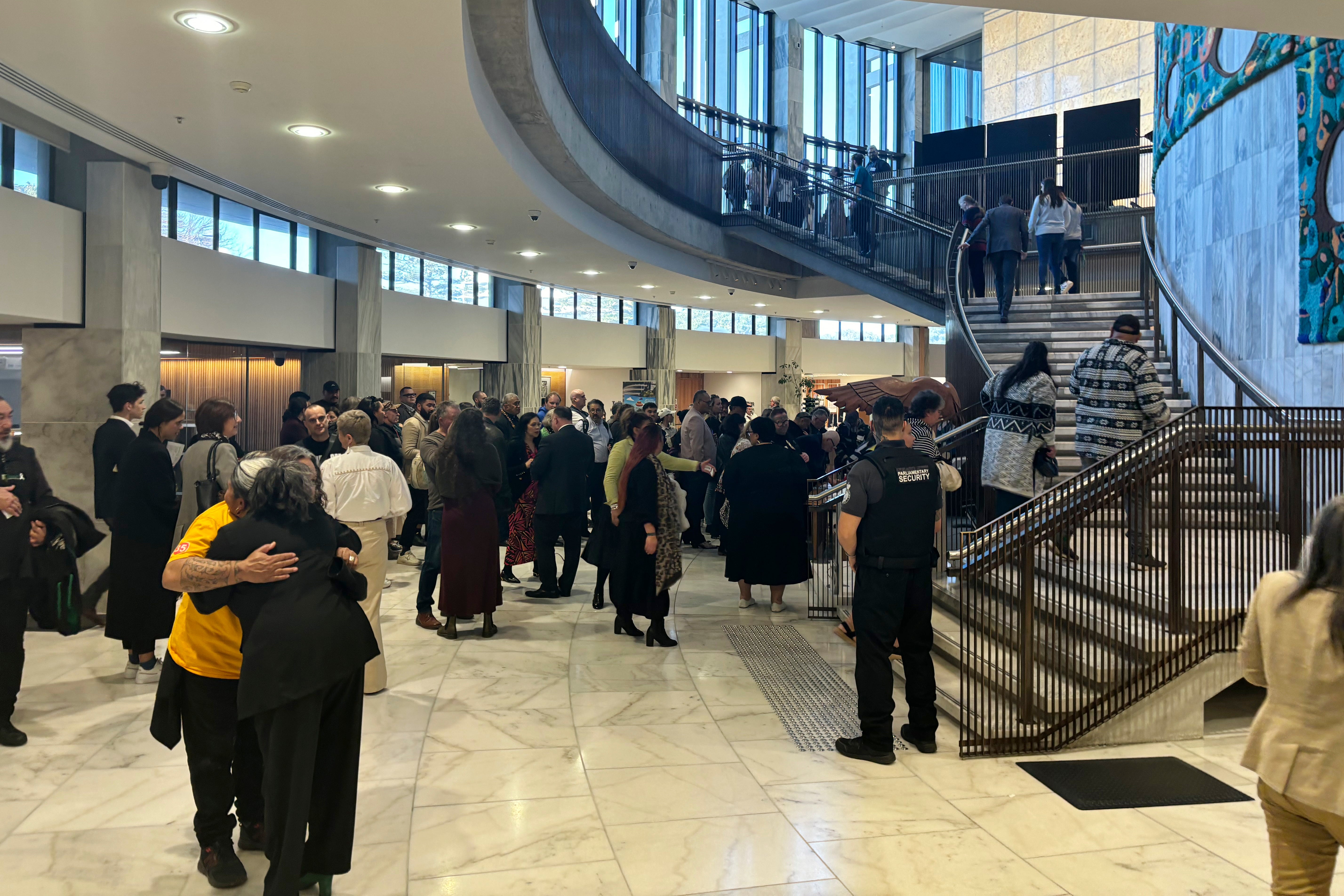 People arrive at the parliament in Wellington for the tabling of the Royal Commission of Inquiry report on 24 July 2024