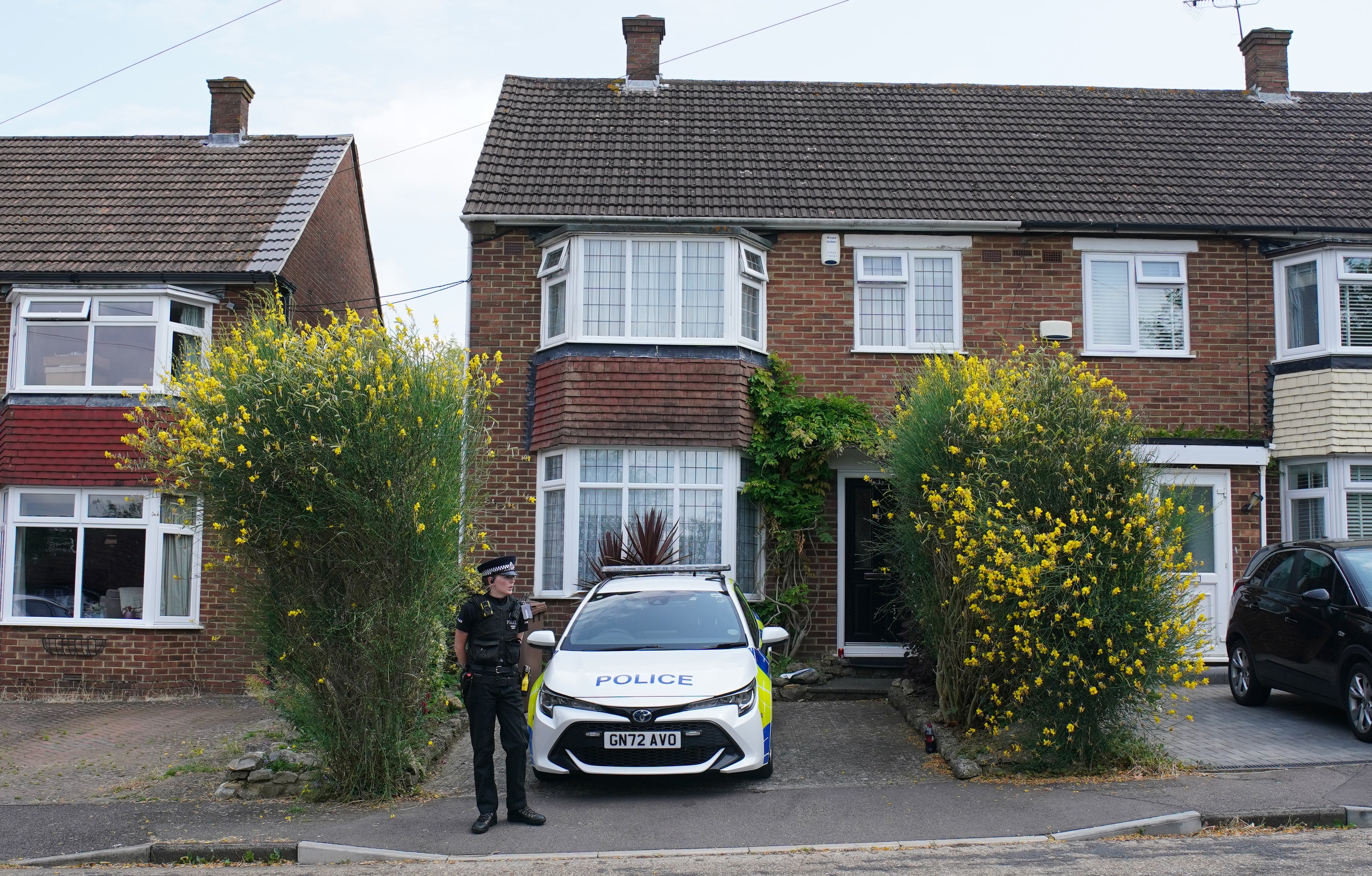 A police officer outside a house on Mooring Road, Rochester in Kent, where a moped was stopped