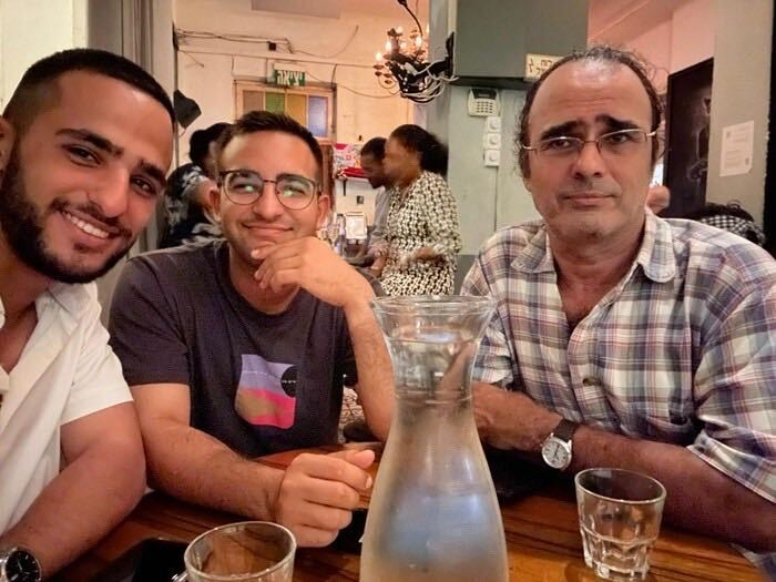 Nimrod Cohen (left) with his brother Yotam (centre) and father Yehuda before the October 7 attacks. Yotam has criticised the Israeli government for expanding its military action in Gaza