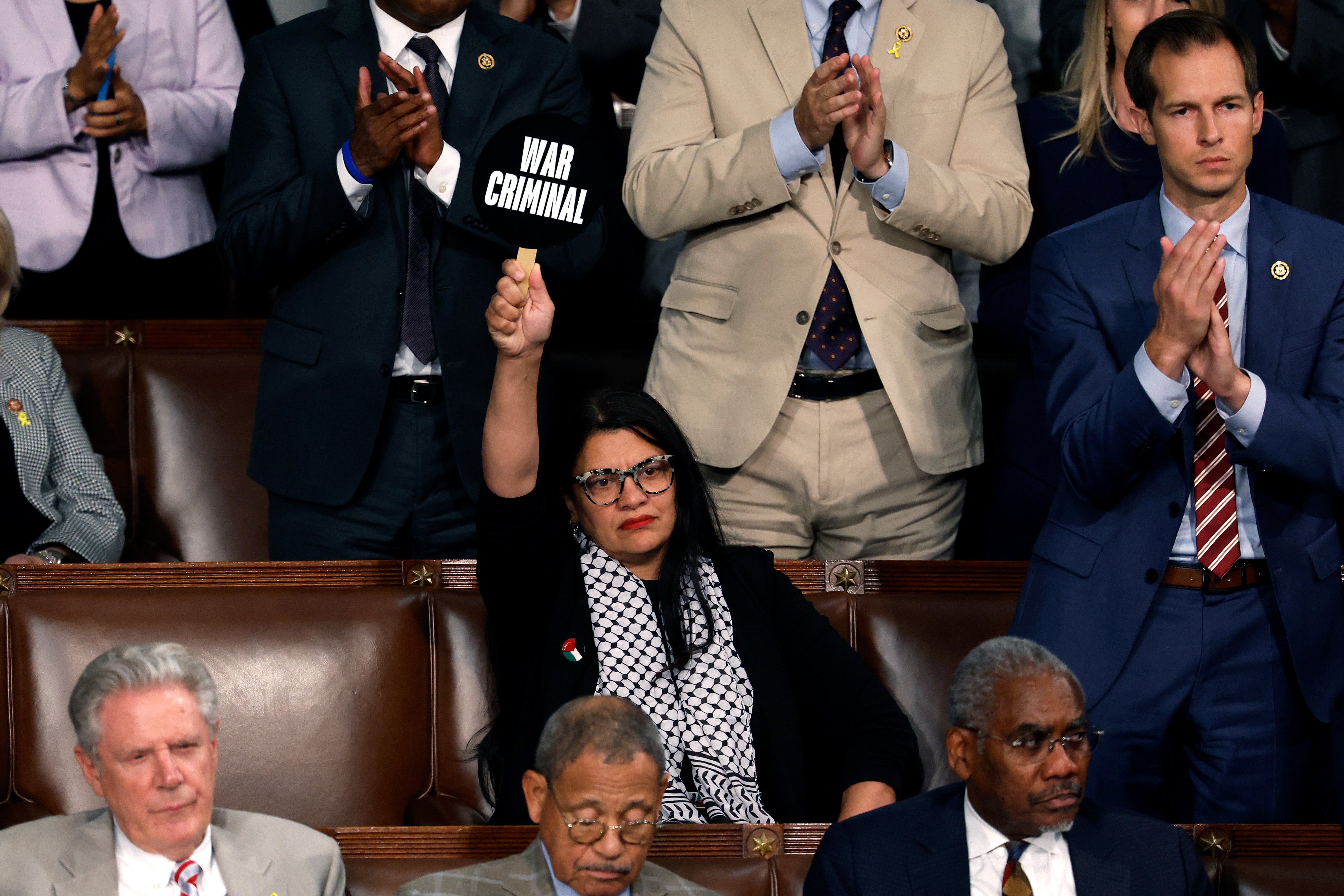 Rashida Tlaib holds a ‘war criminal’ sign during Netanyahu’s address to Congress