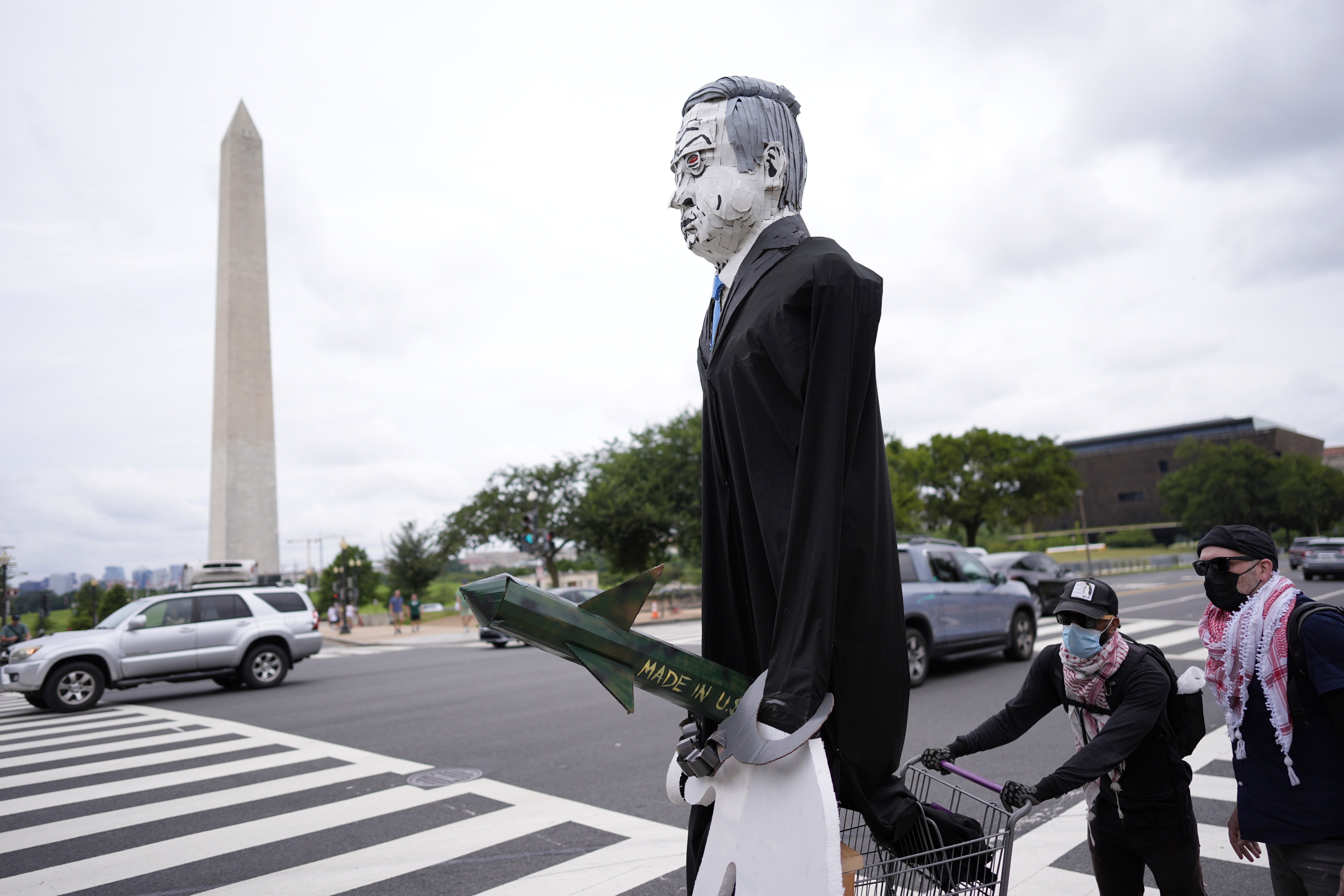 Protesters push an effigy of Benjamin Netanyahu down a street in Washington