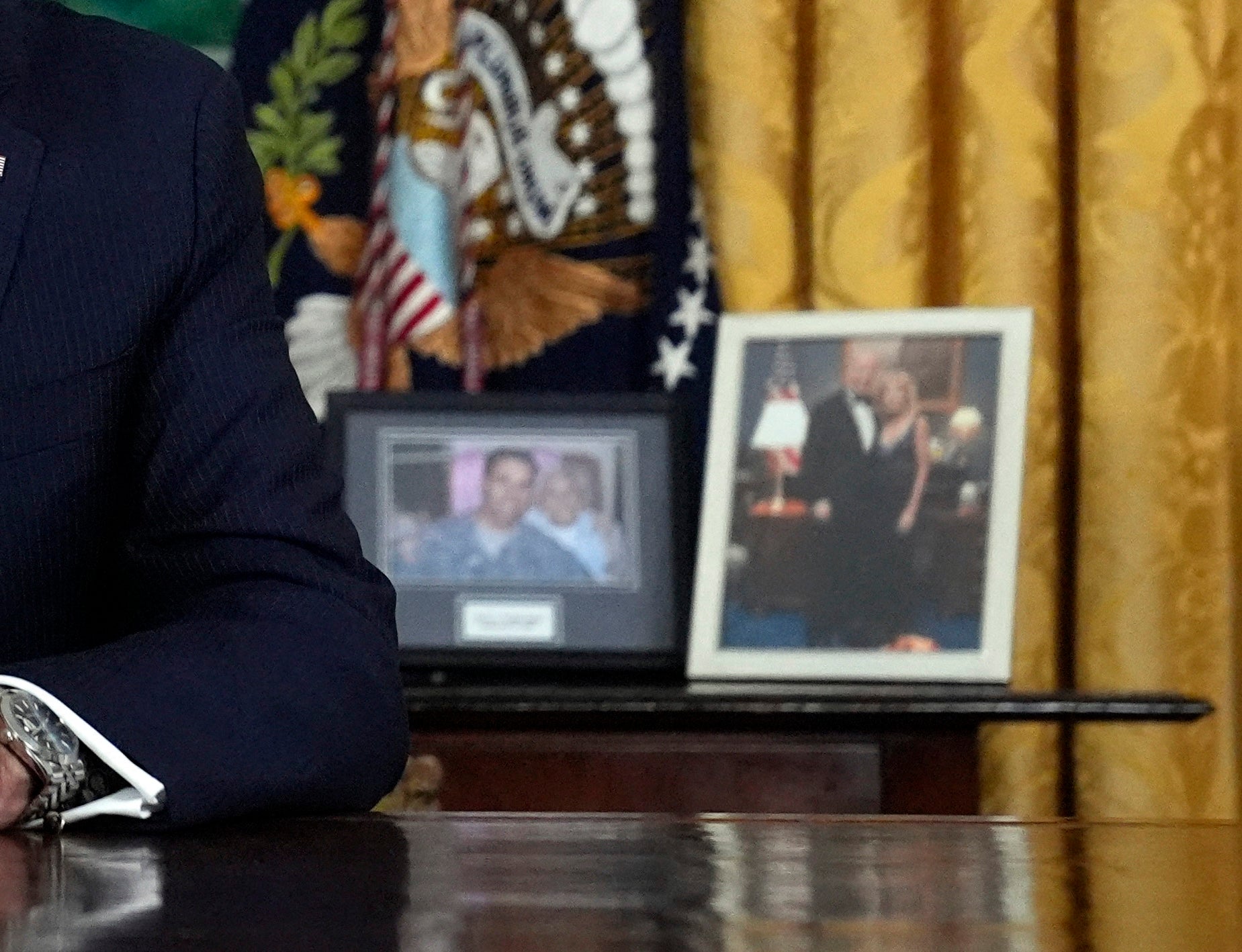 A picture of Biden and First Lady Jill sat to his right when he spoke from the Oval Office