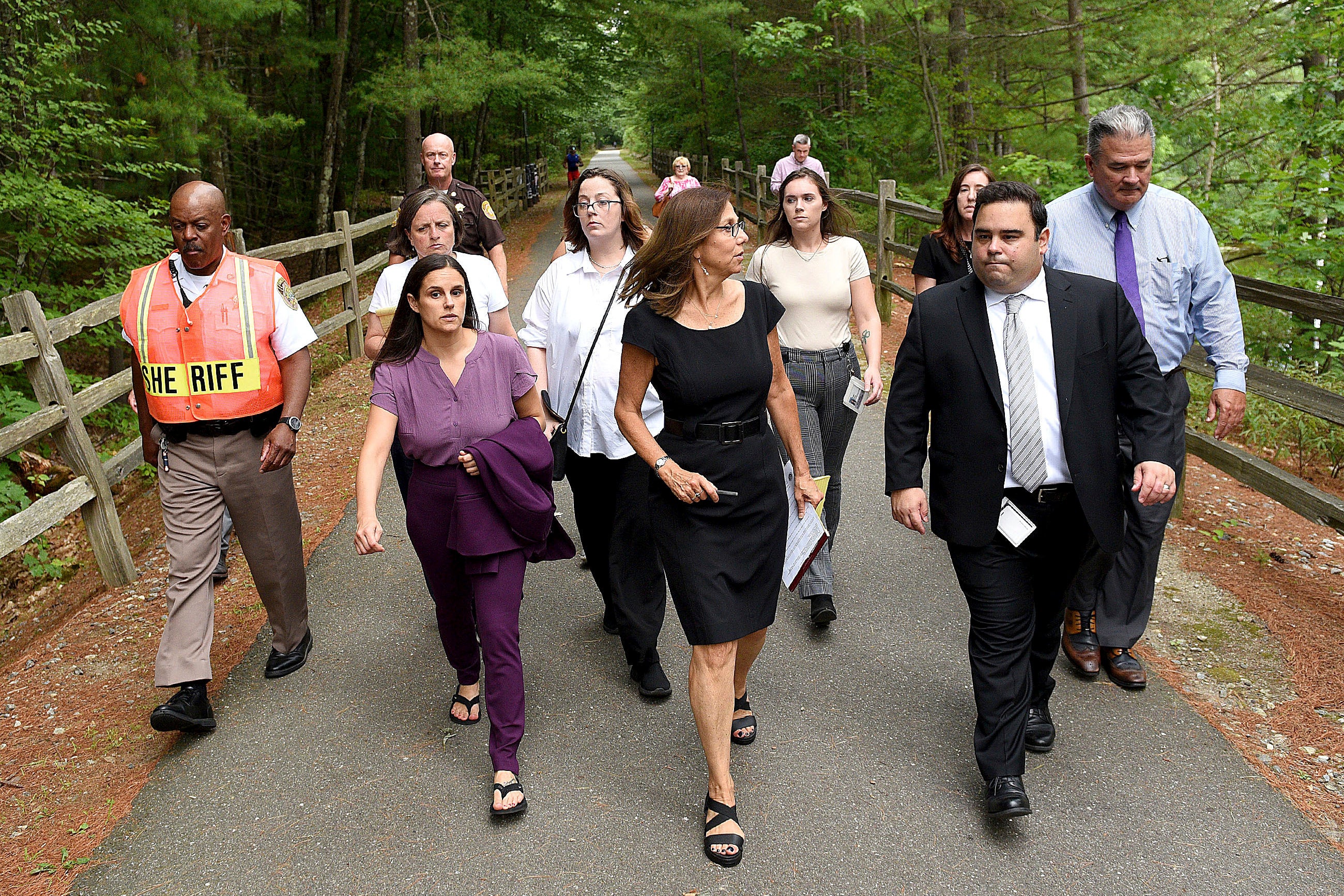 Superior Court Justice Amy Messer (center in black) walks along the Piscataquog River Rail Trial with a group including Eckersley (center in White)