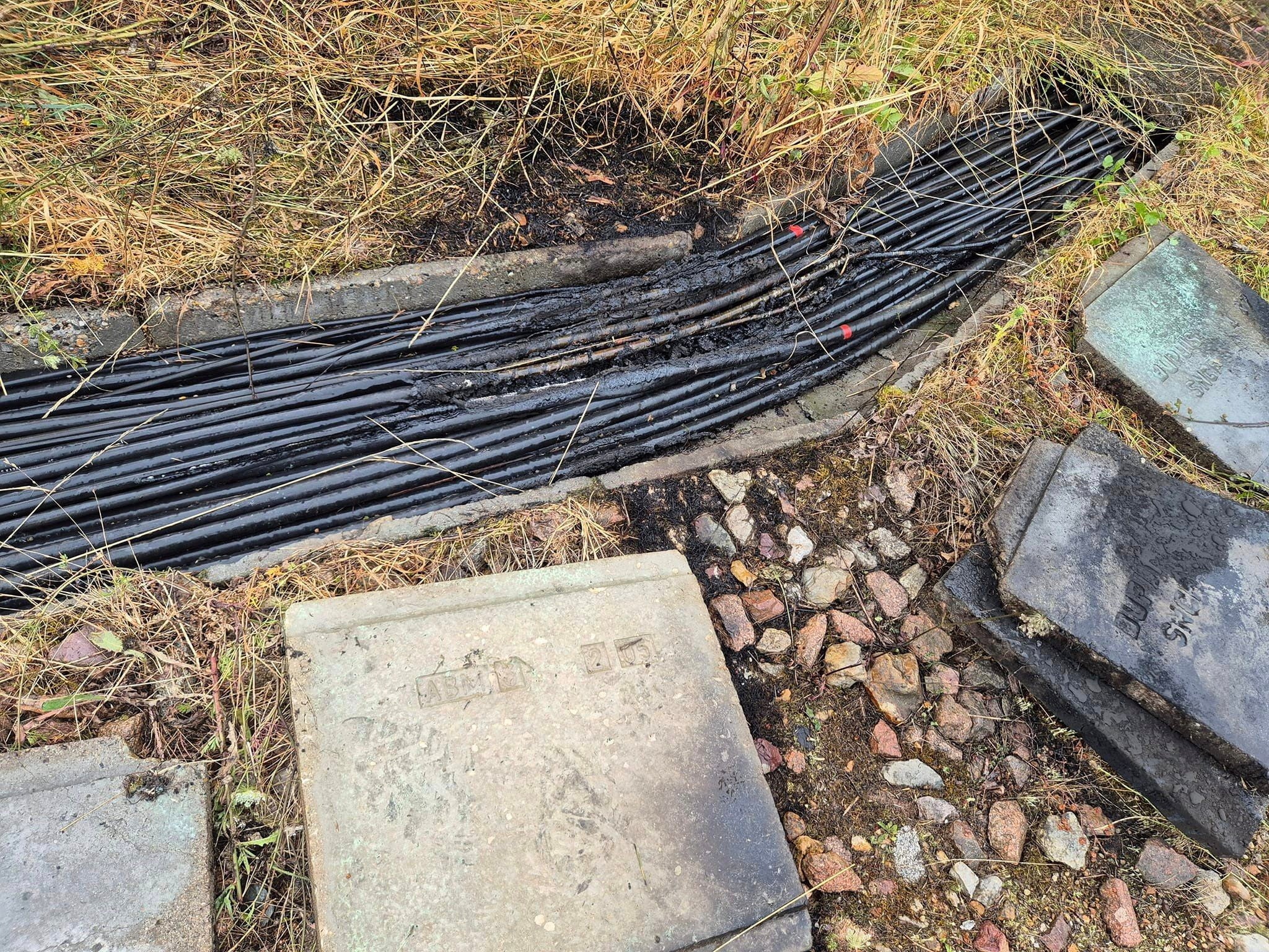 Damaged cables lie near a site close to Courtalain where vandals targeted France's high-speed train network