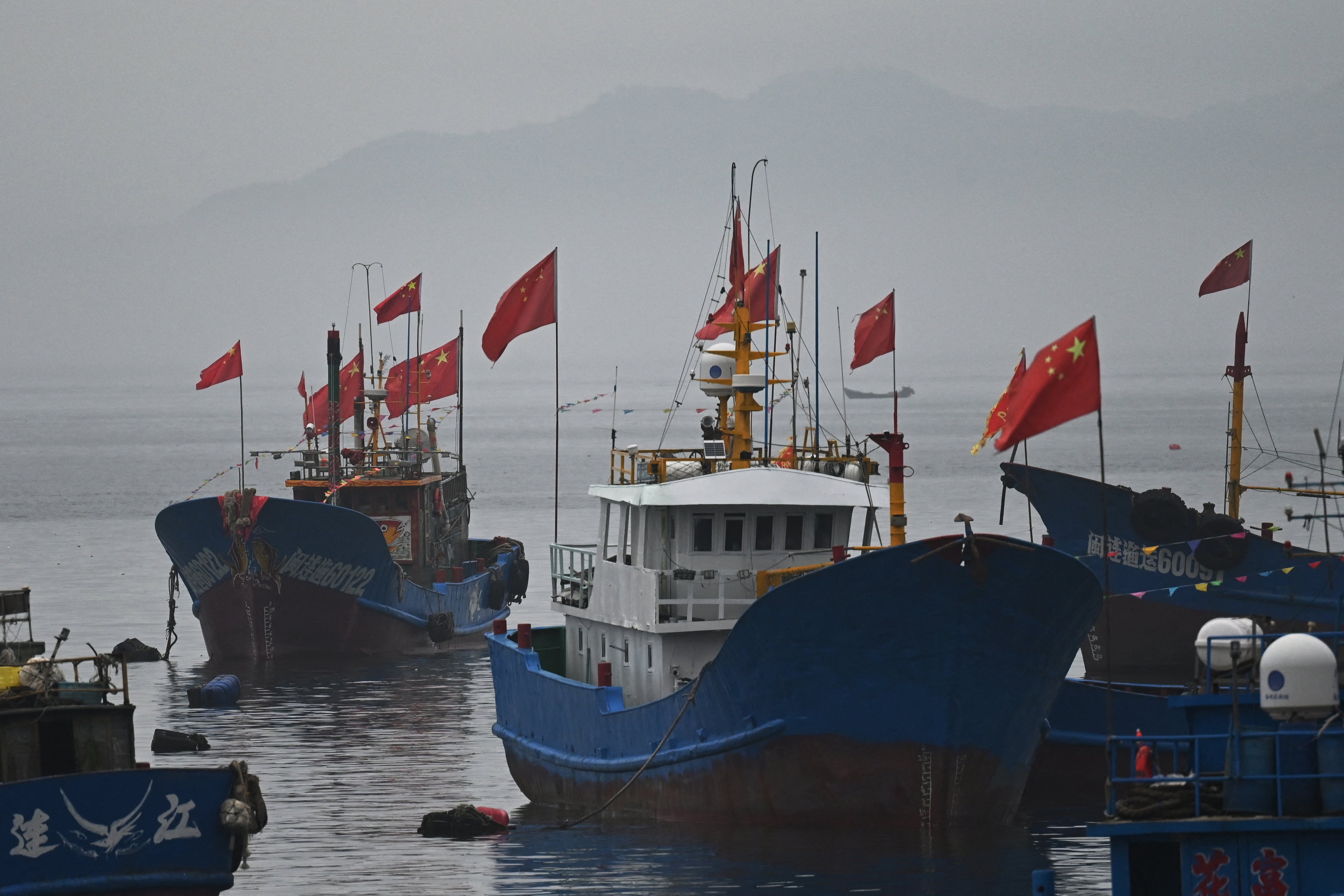 Chinese flags fly on fishing boats in Tailu village, on the Chinese coast opposite Taiwan’s Matsu islands, in China’s southeast Fujian province on 25 May 2024