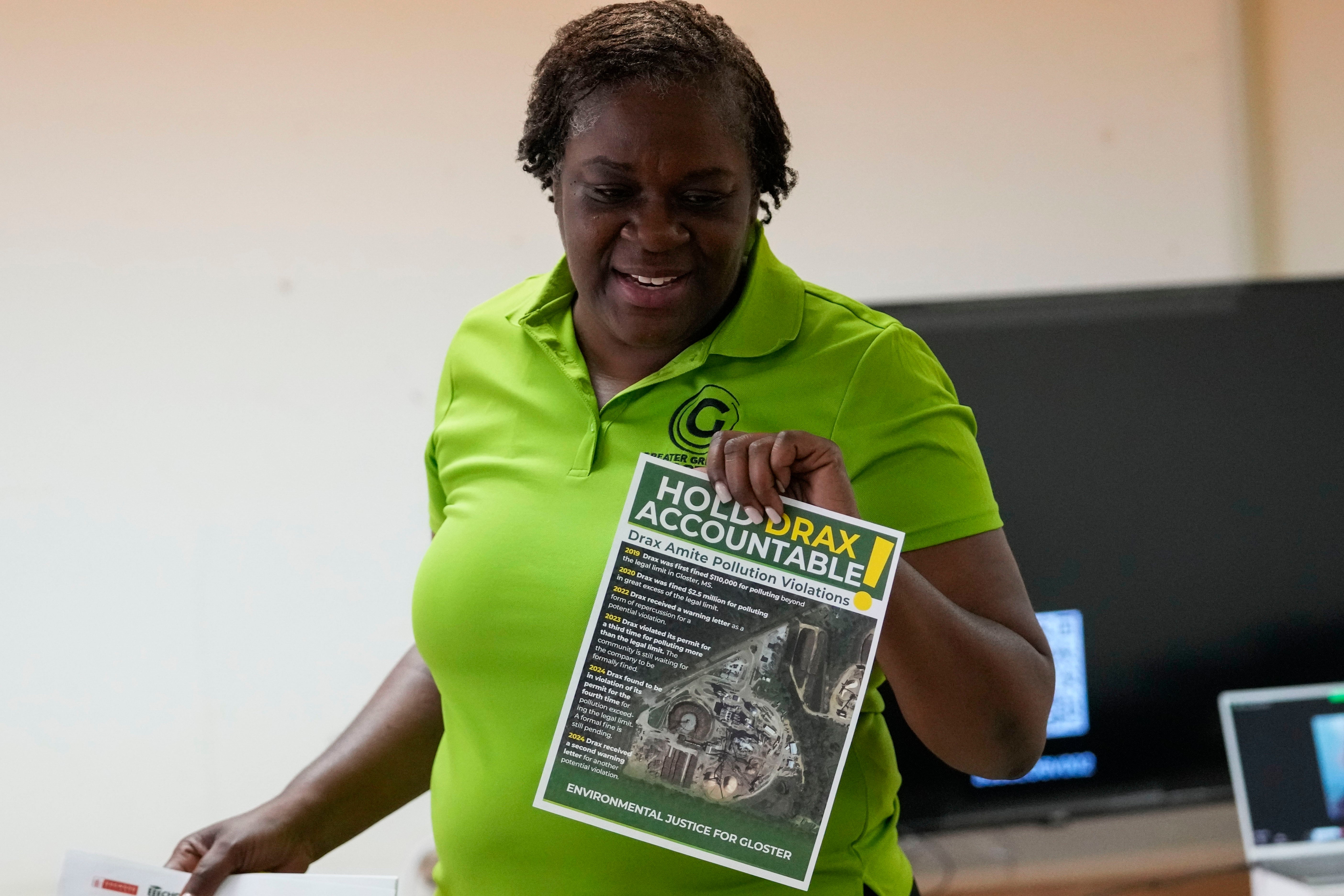 Krystal Martin, a Gloster native, shows pamphlets during a community