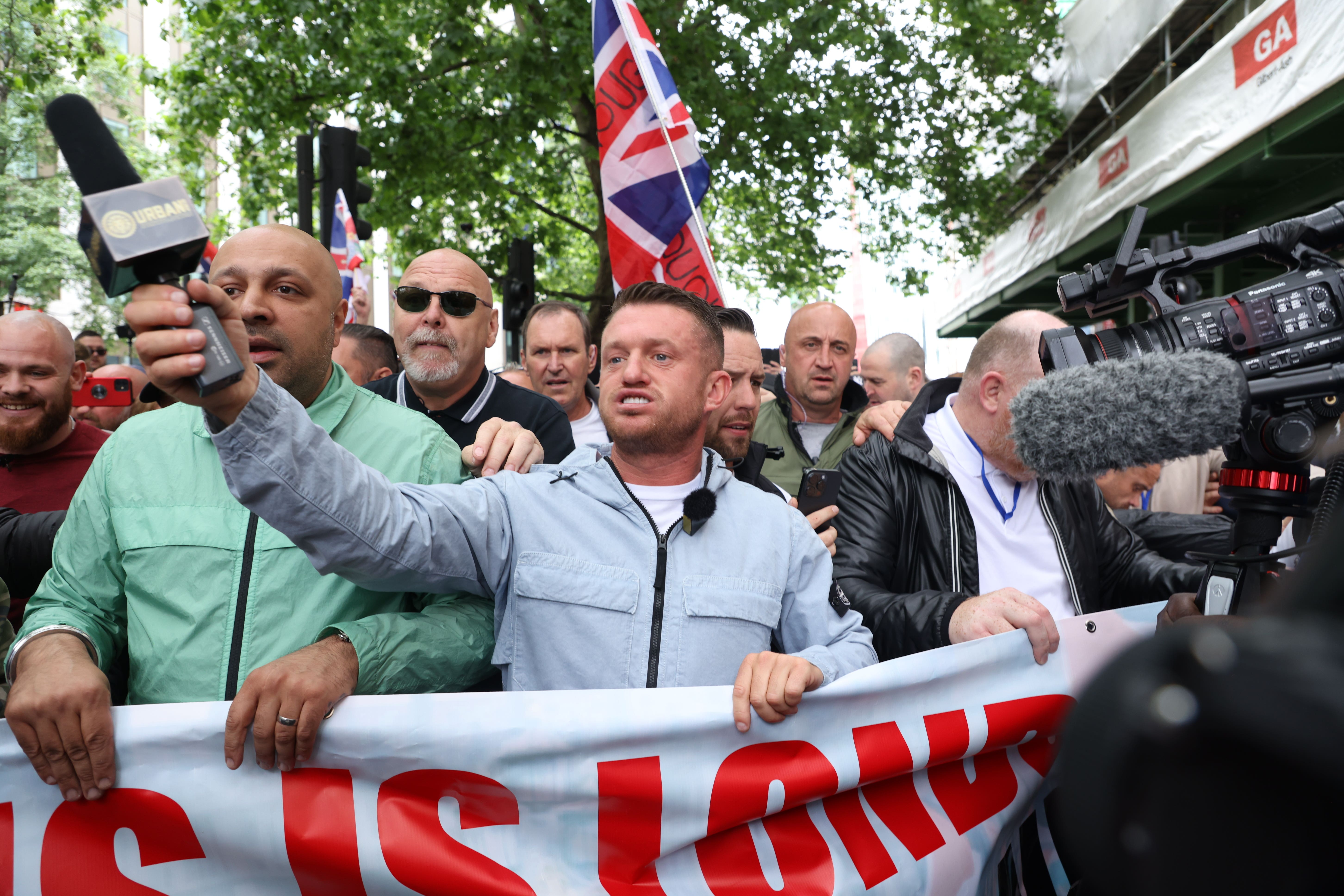 Tommy Robinson (centre), whose real name is Stephen Yaxley Lennon, leads a protest march through London to Parliament Square where speeches will take place and a film will be shown. Groups from across the UK linked to football disorder are expected to attend the event the Metropolitan Police said. Picture date: Saturday June 1, 2024.