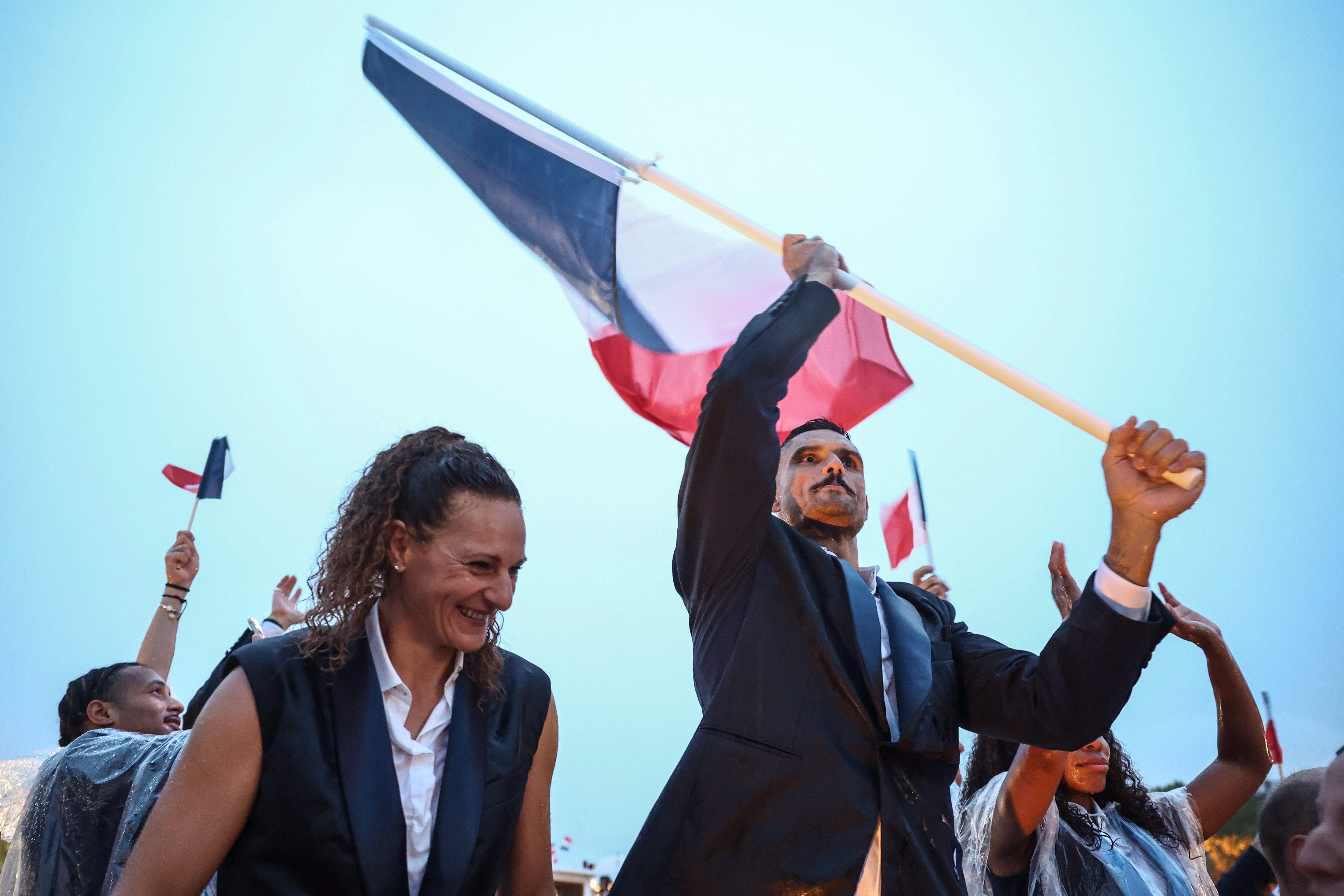 France’s flag bearer Florent Manaudou (R), France’s flag bearer Melina Robert-Michon