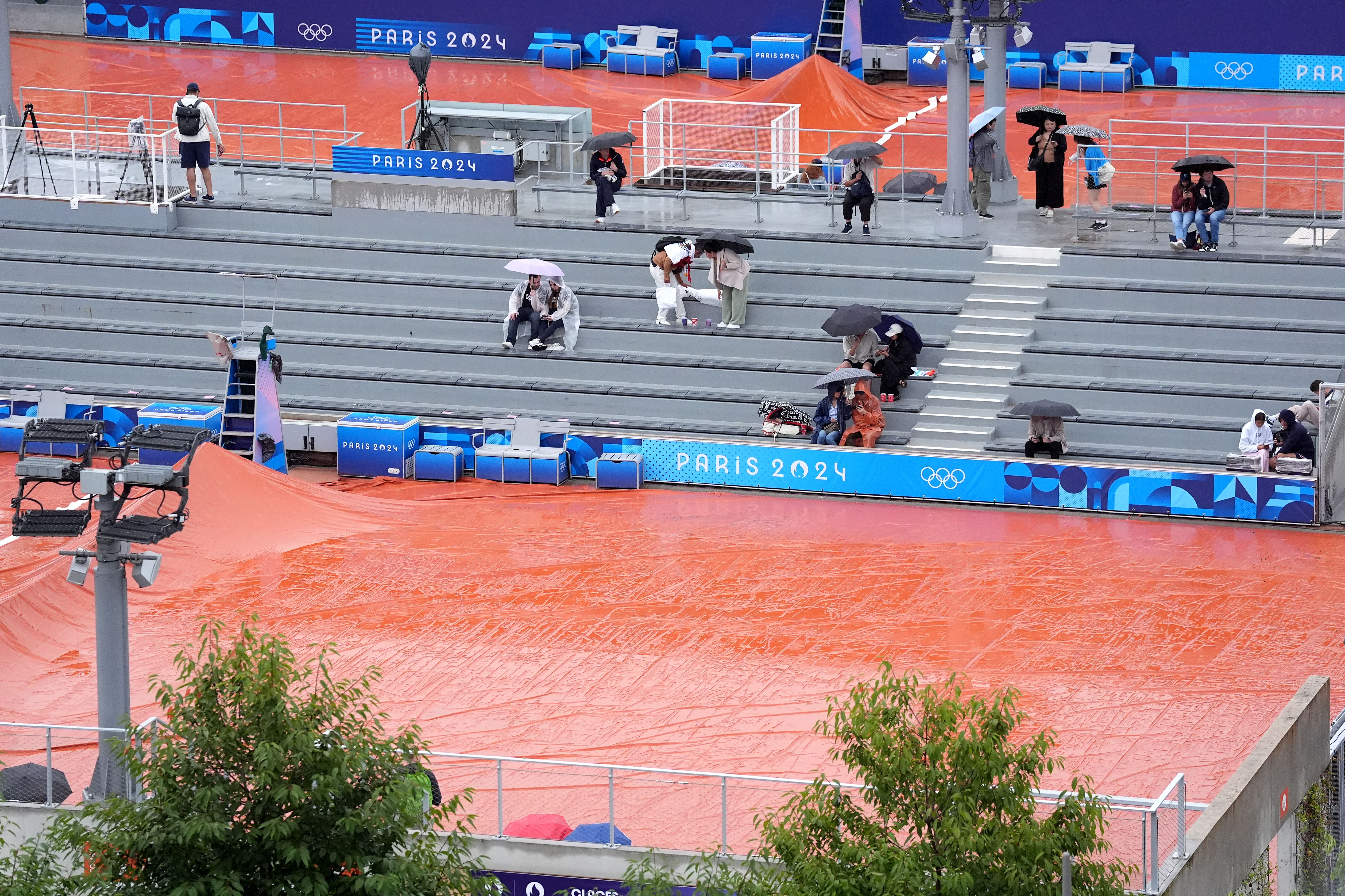 Rain stops play at Roland Garros during the women’s singles first round match between Poland’s Iga Swiatek and Romania’s Irina-Camelia Begu on day one of the Paris Olympics (Martin Rickett/PA).