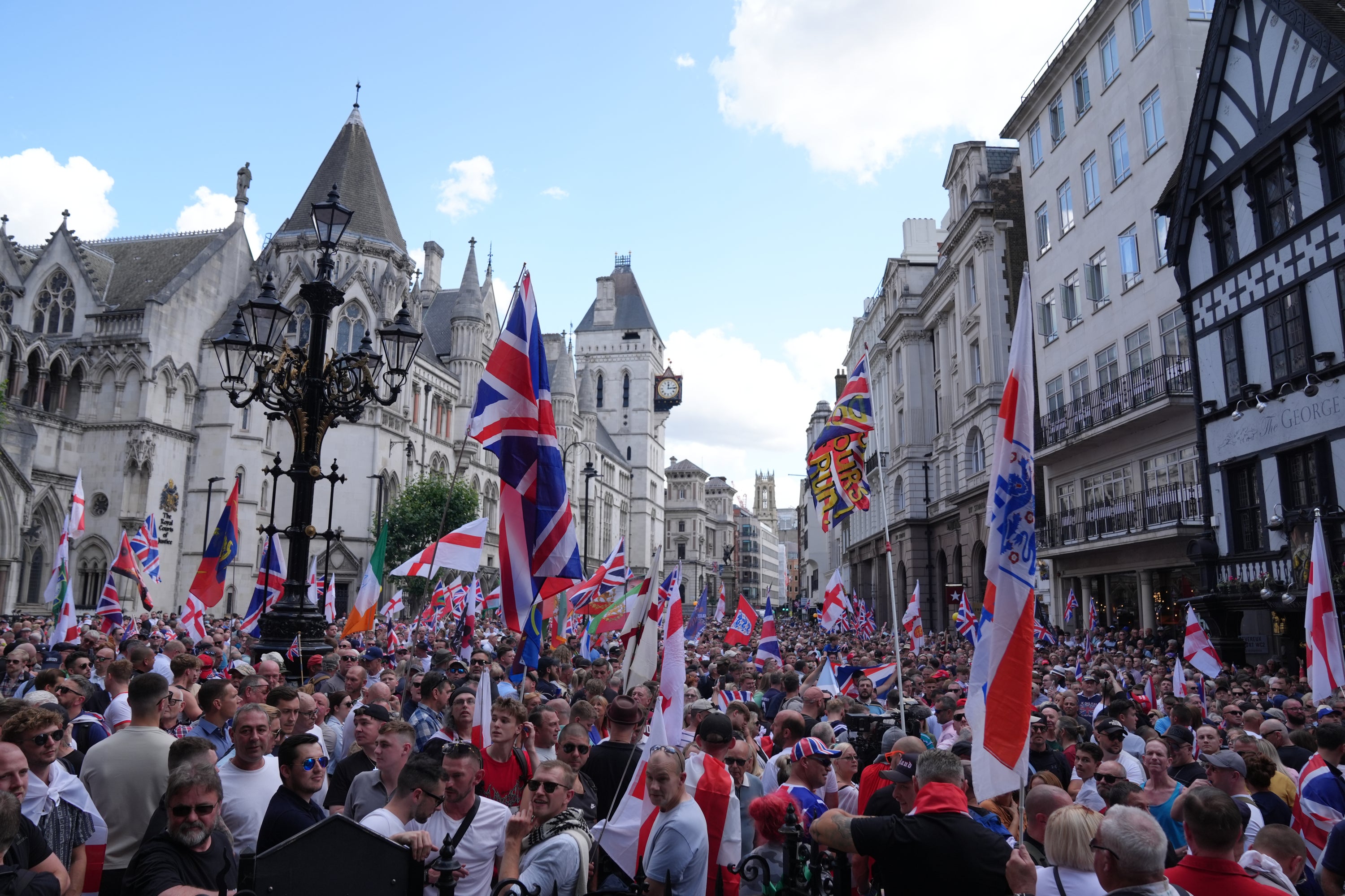 People take part in a protest march organised by Tommy Robinson in central London