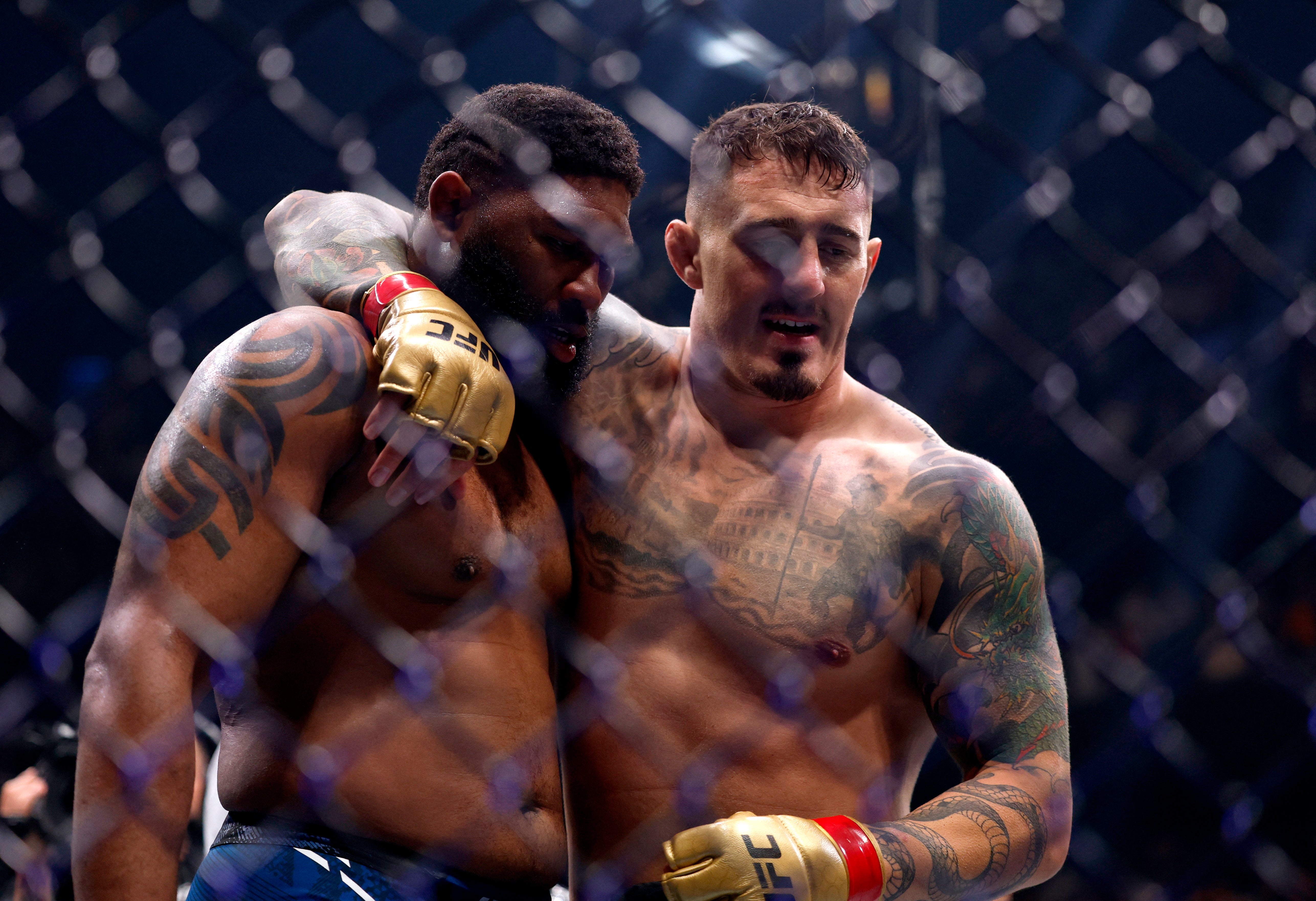 Tom Aspinall (right) consoles Curtis Blaydes after knocking out the American