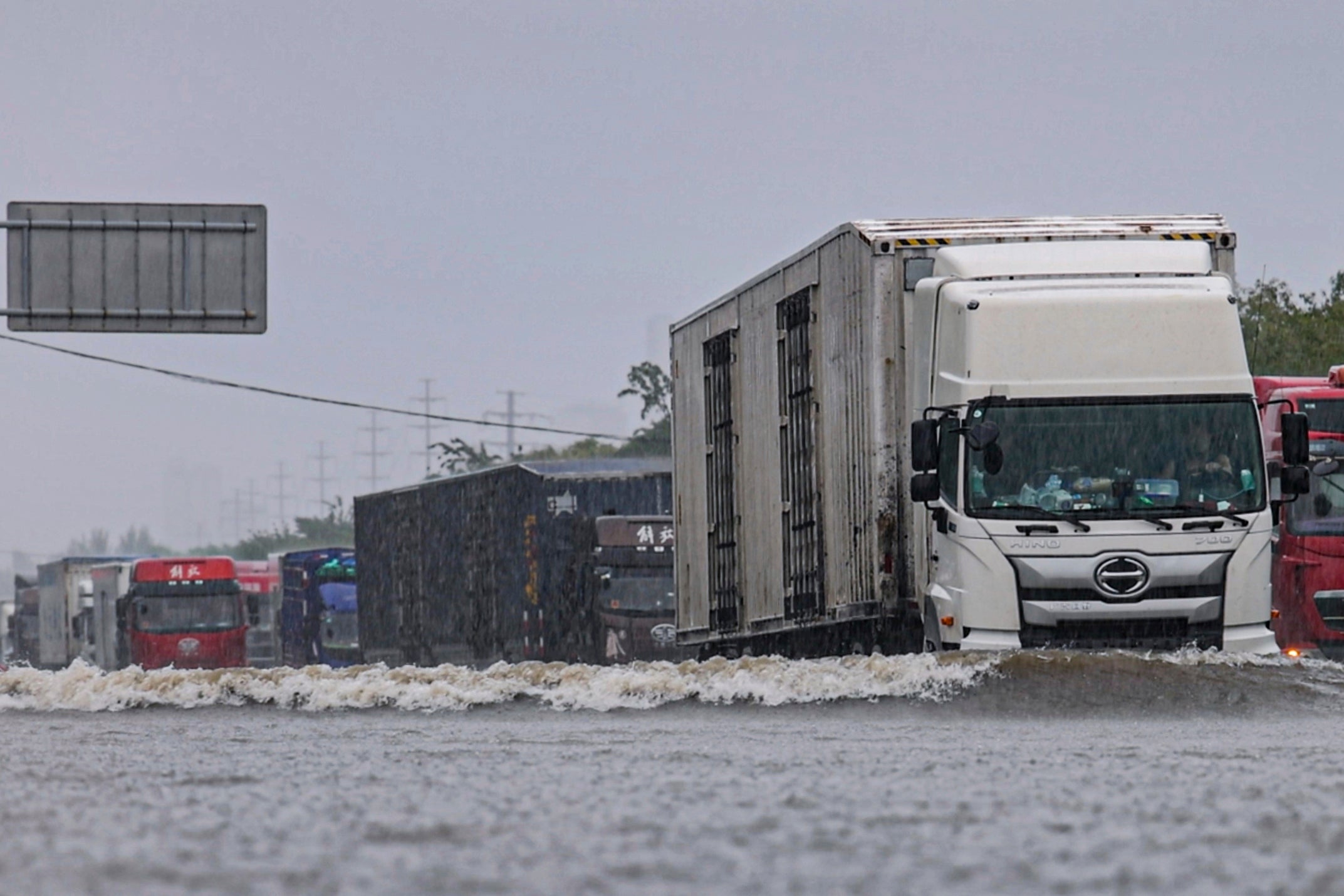 In this photo released by Xinhua News Agency, vehicles drive through a flood waters in Shenyang, northeastern China's Liaoning Province, 26 July 2024