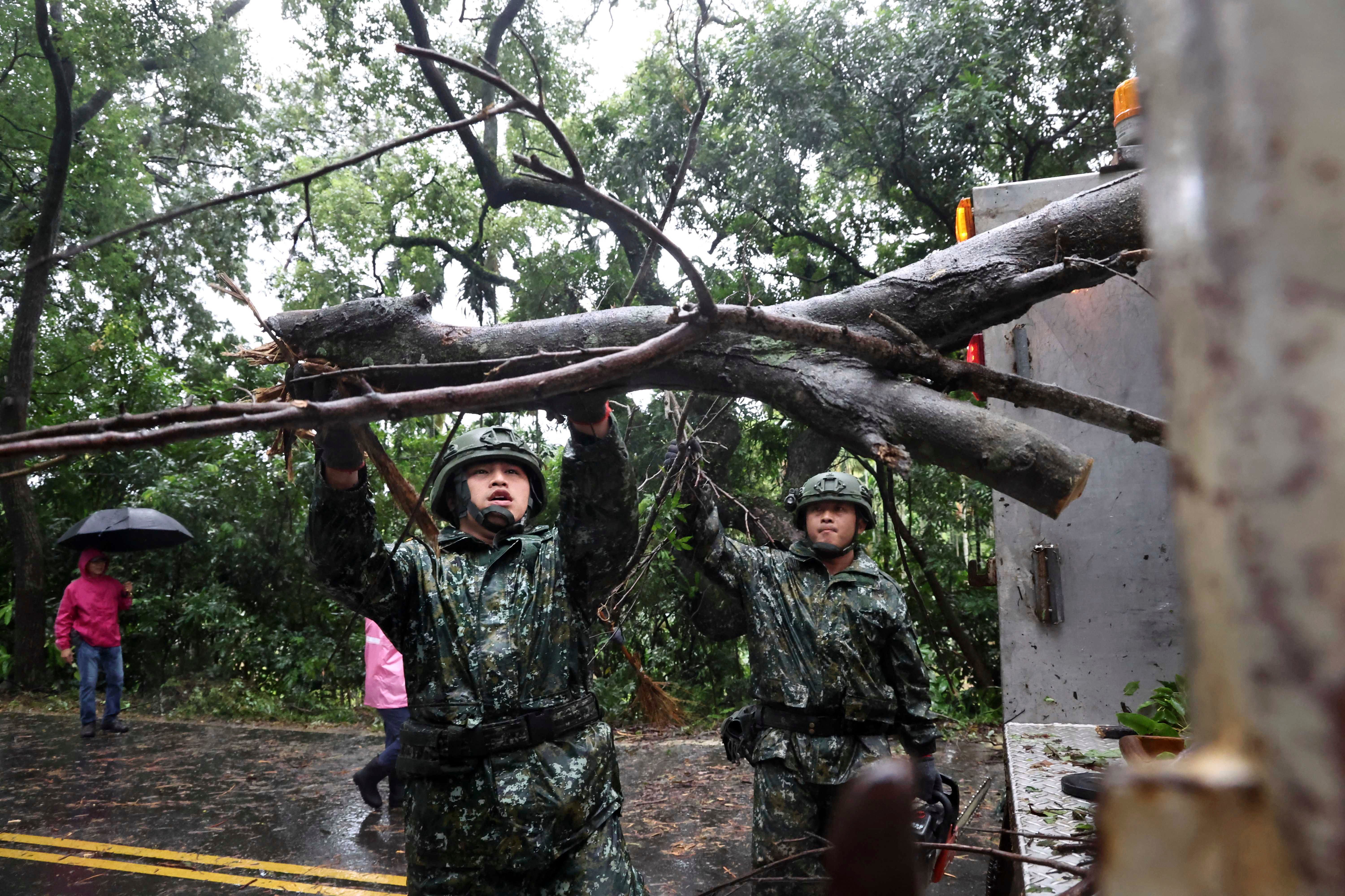 In this photo released by the Taiwan Ministry of National Defense, Taiwanese soldiers clear fallen trees in the aftermath of Typhoon Gaemi in Kaohsiung county in southwestern Taiwan, Friday, 26 July 2024