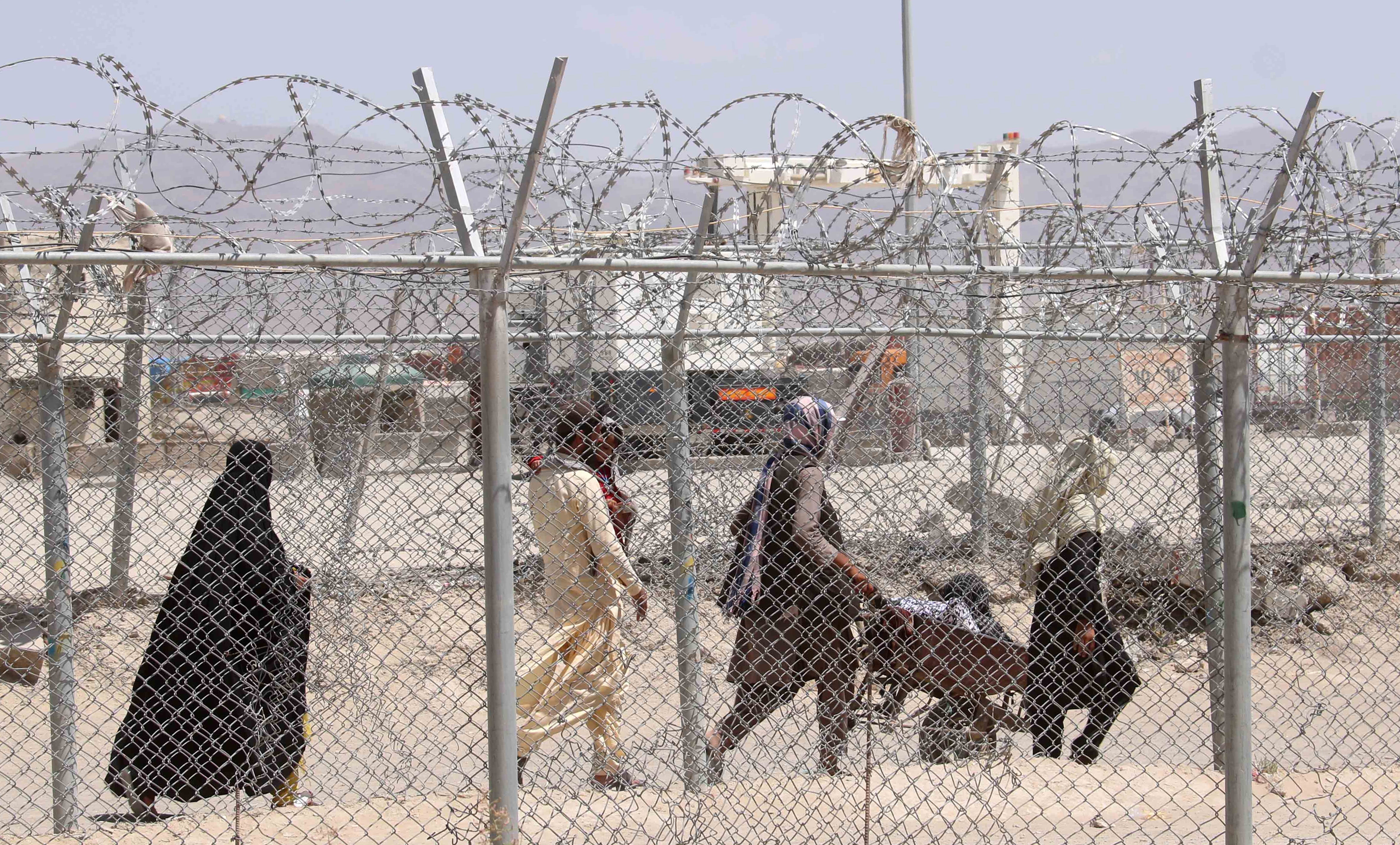 File. People walk near Pakistan’s border with Afghanistan