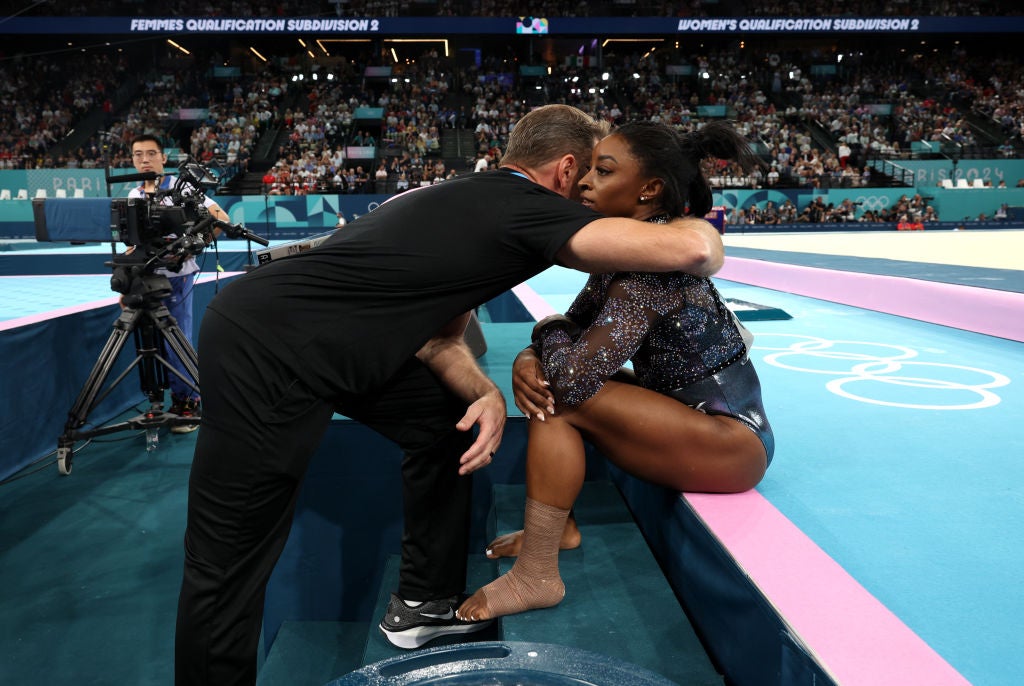 Biles with strapping on her left leg