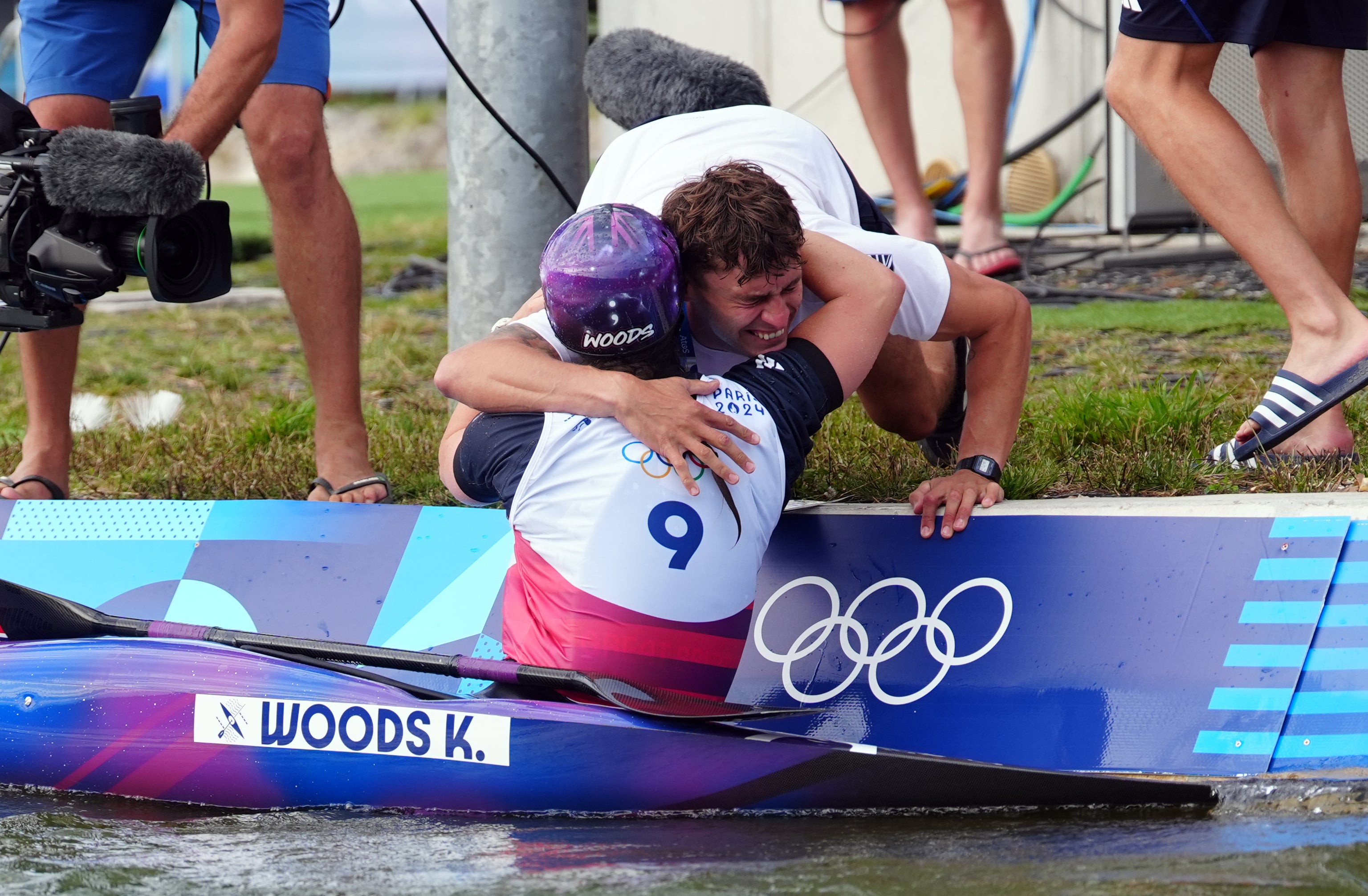 Kimberley Woods hugs TeamGB team-mate Adam Burgess after her run in the women’s kayak single final at the Paris Olympics (David Davies/PA).