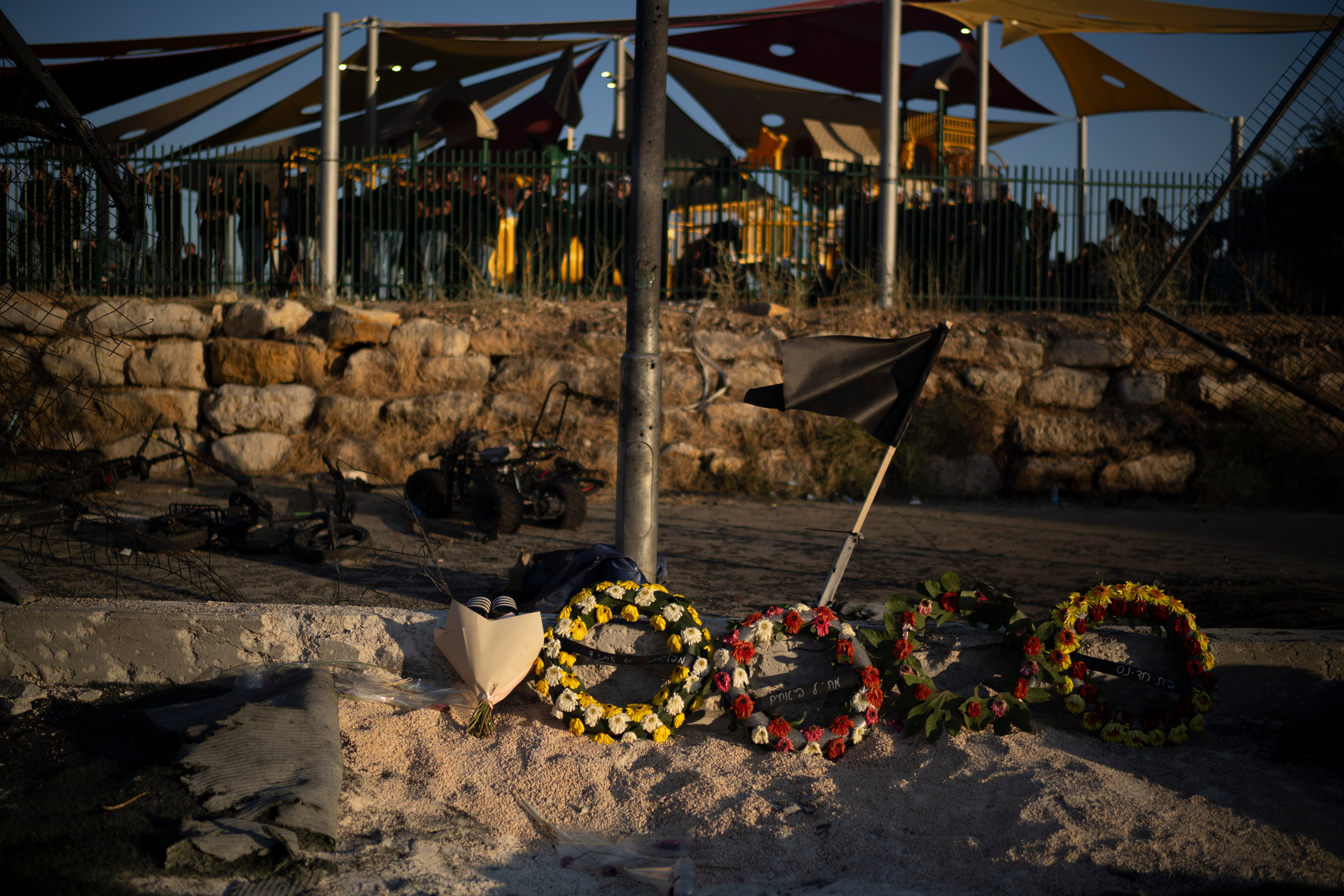 Wreaths of flowers are placed on the site of a rocket strike that killed children and teenagers at a soccer field in the village of Majdal Shams, in the Israeli-annexed Golan Heights